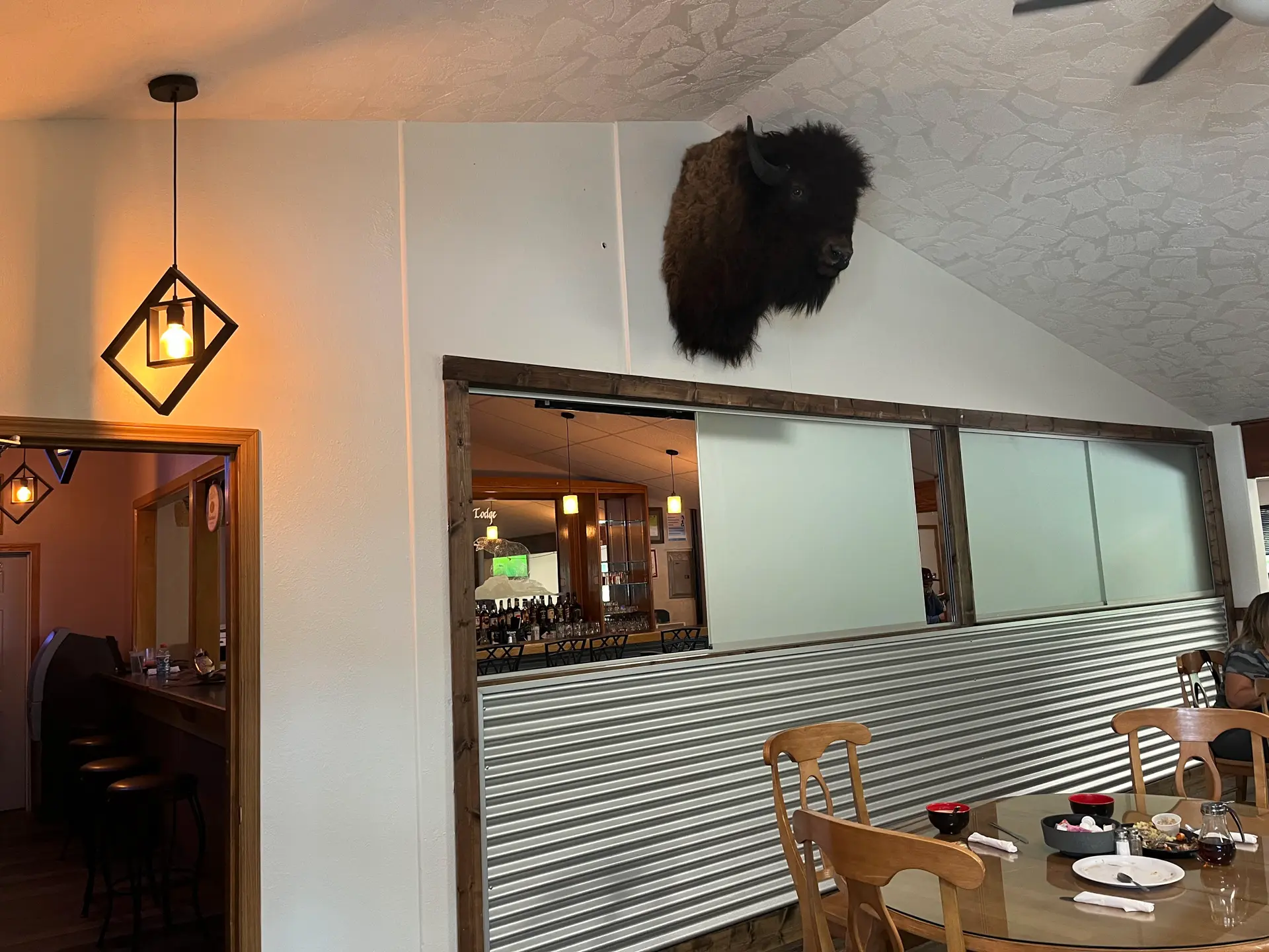 Trophy Grill dining room and bar area with tables and chairs.
