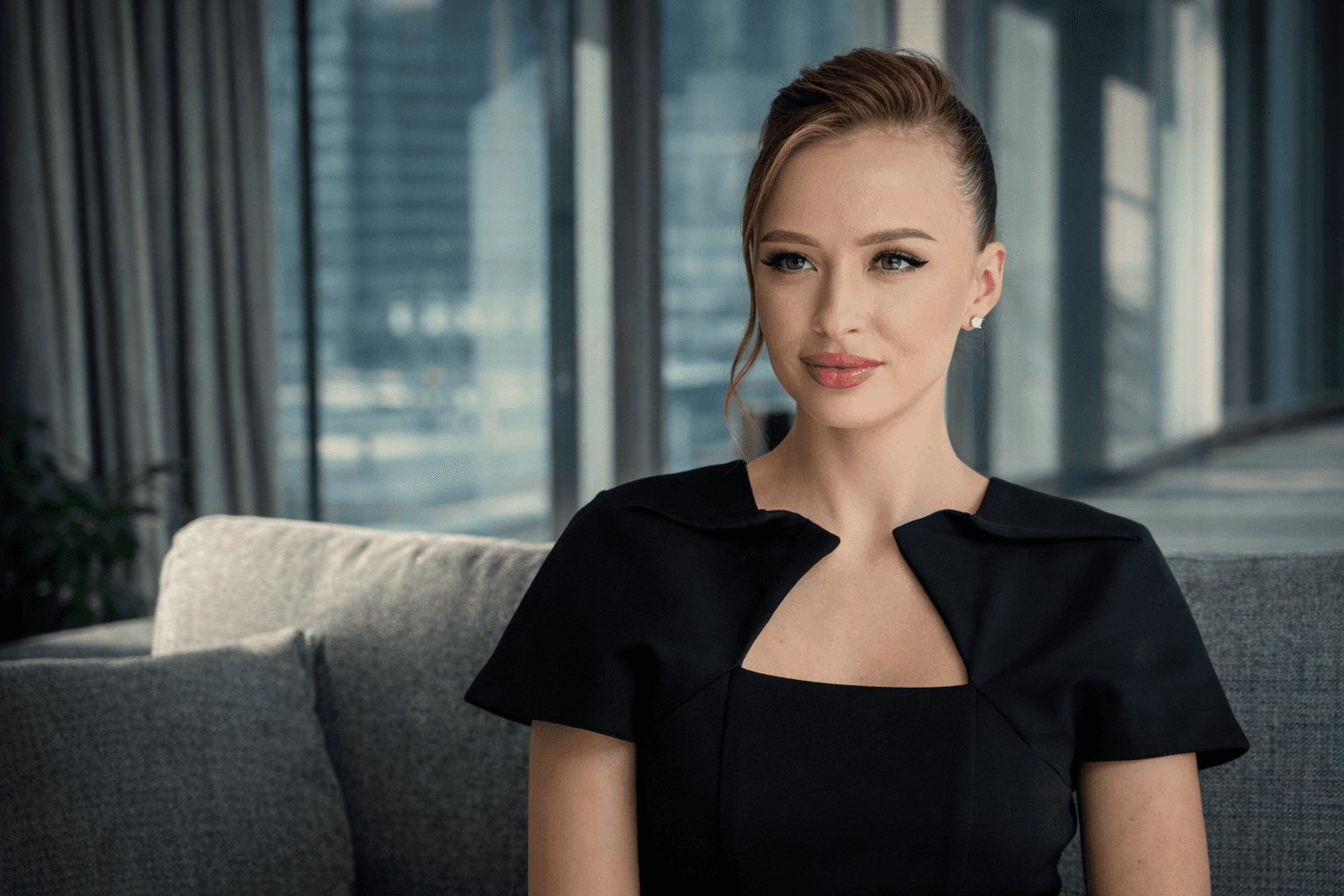 woman sitting around table holding tablet