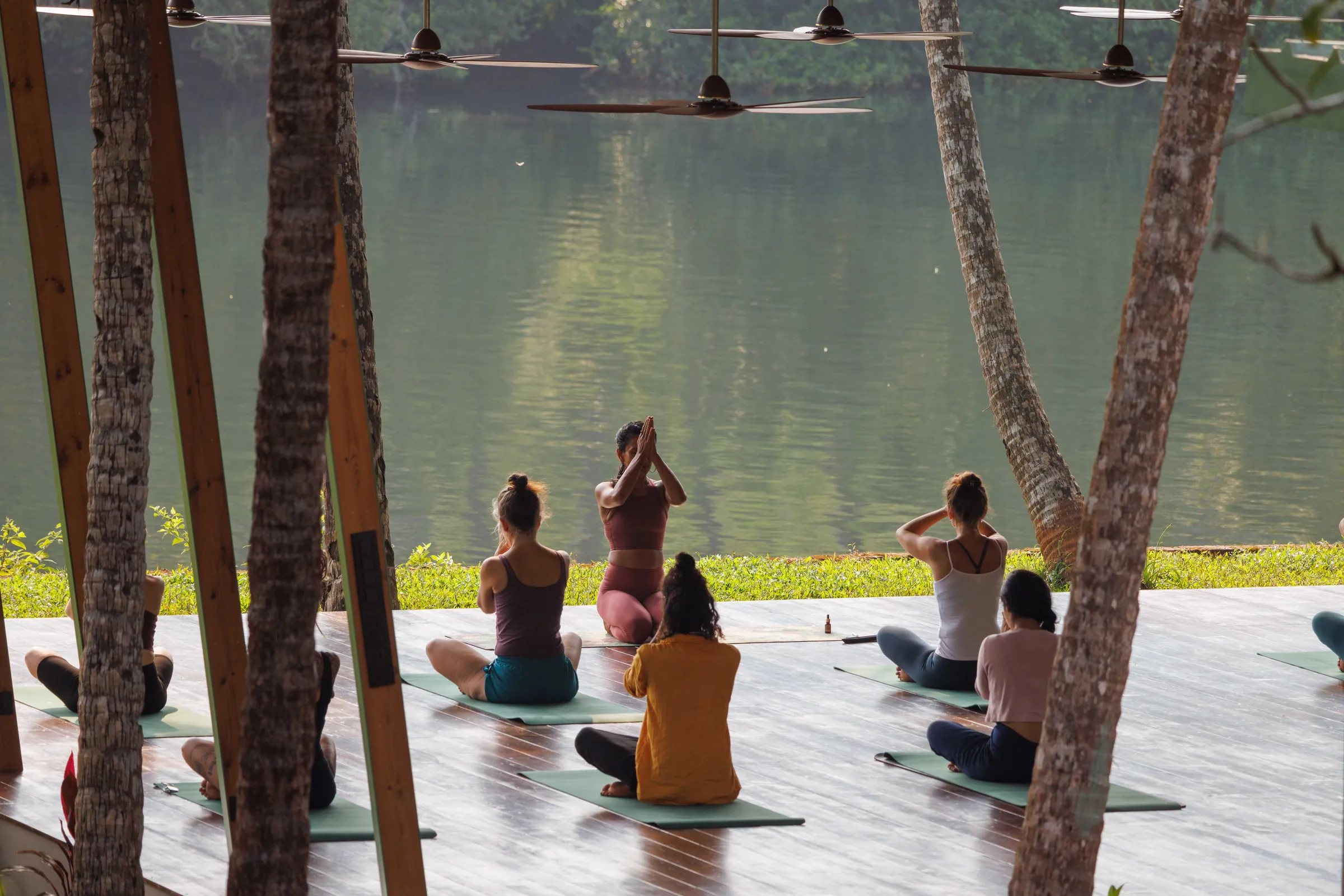Retreat group in seated practice facing the Talpona River at Jaali River Sanctuary