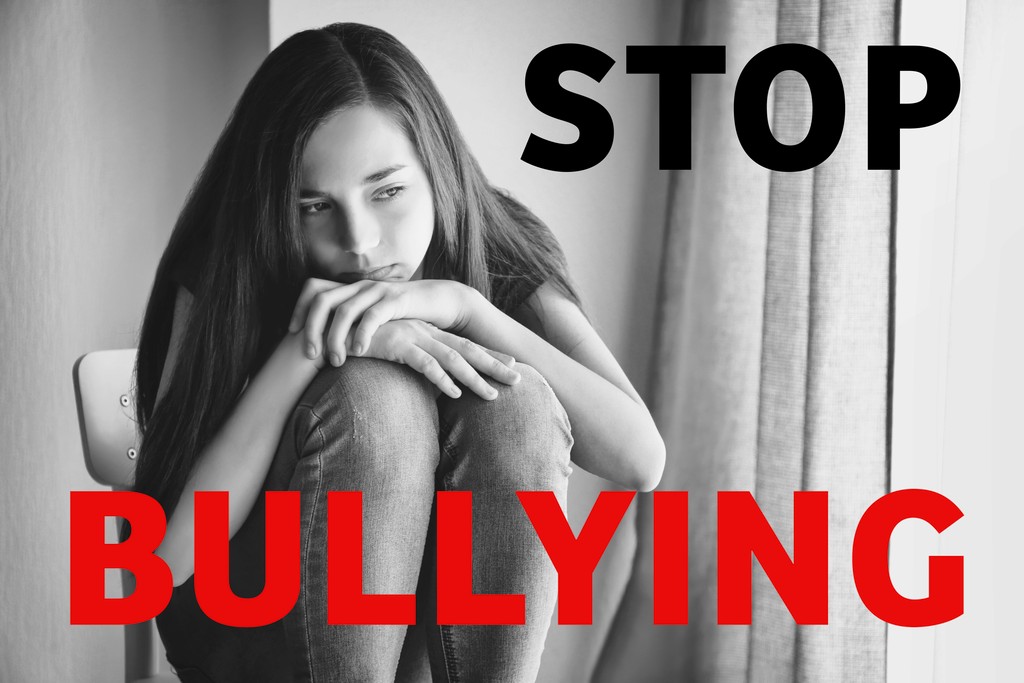 Depressed teenage girl with text "stop bullying"