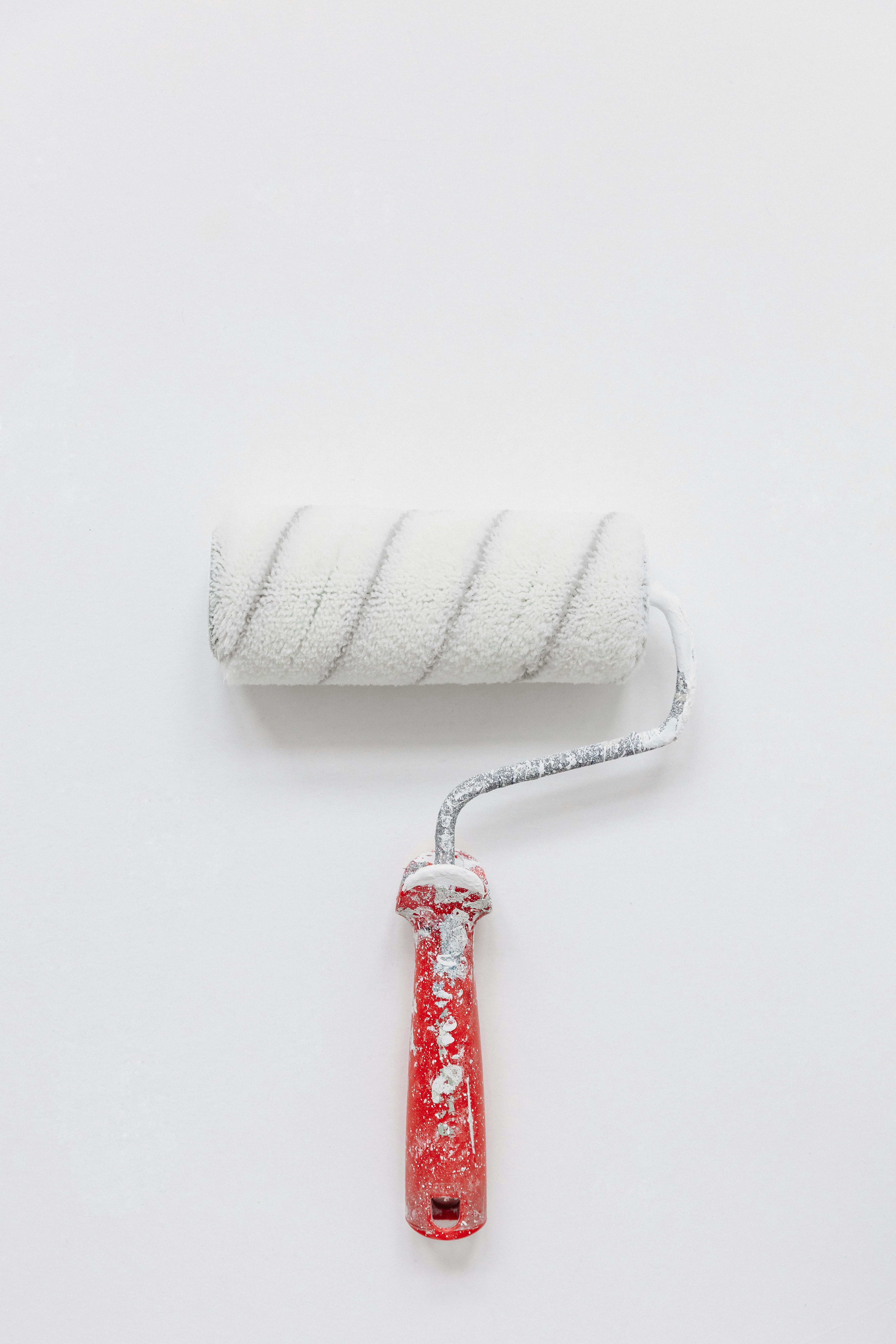 A paint brush roller against a white background