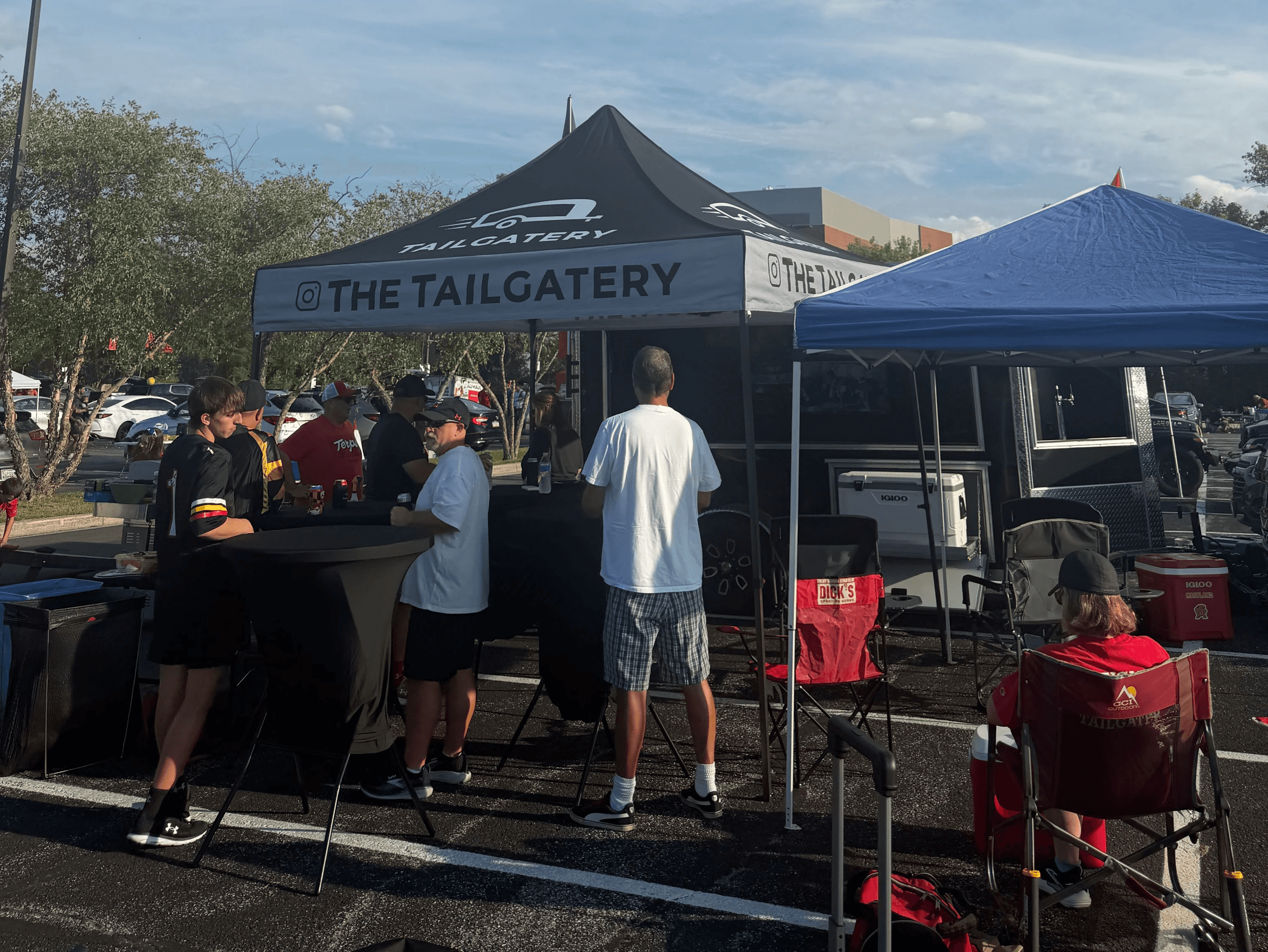 Complete Tailgatery trailer and canopy setup at a daytime event.