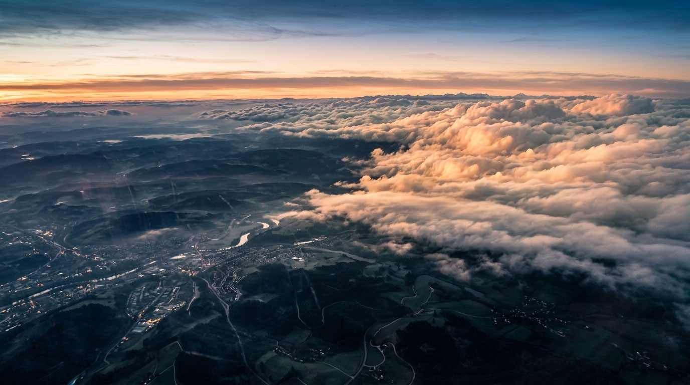 Rolling hills and distant mountains at sunrise