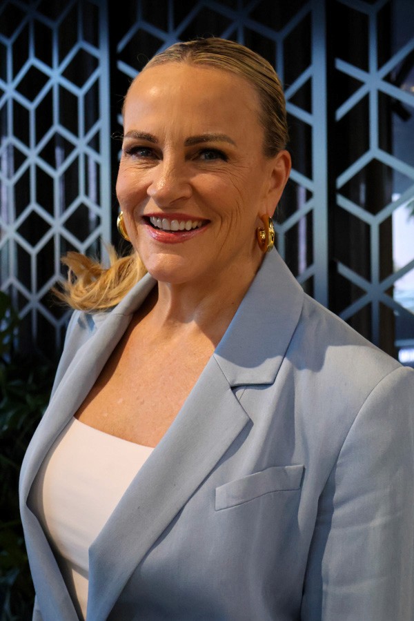 corporate portrait of a woman in a blue suit