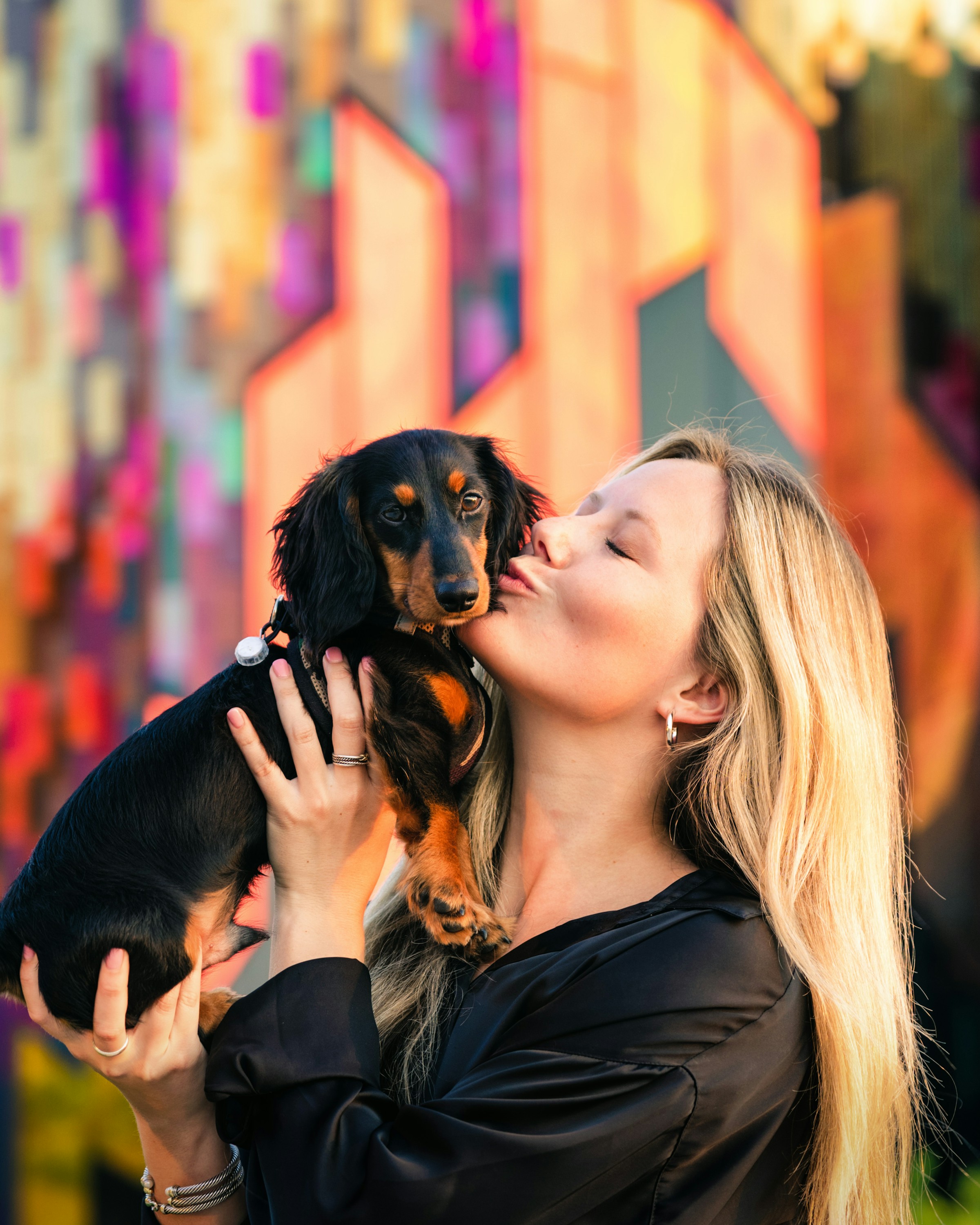 Clara kissing her dachshund Pip