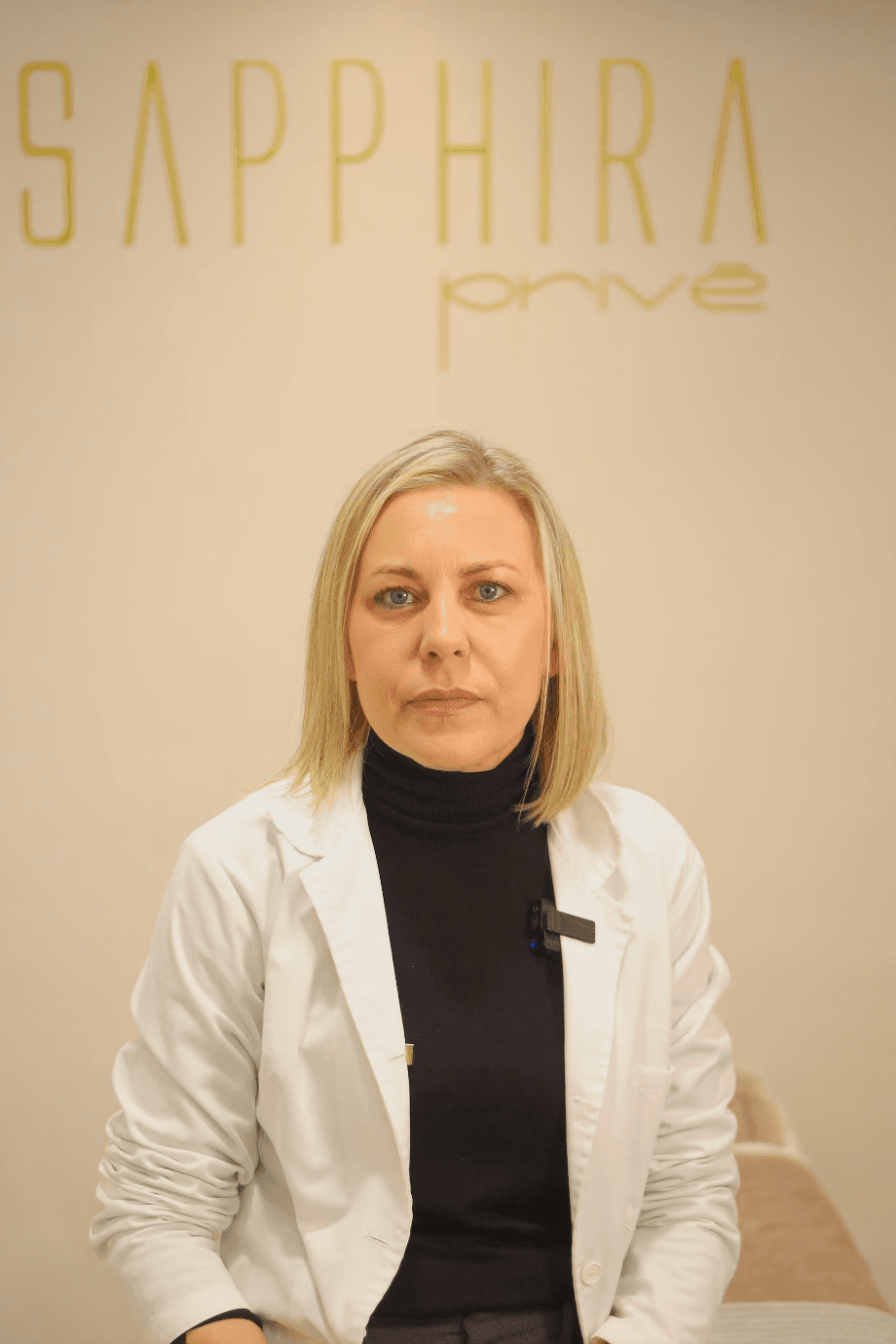 Portrait of medium brown and white dog on pink background
