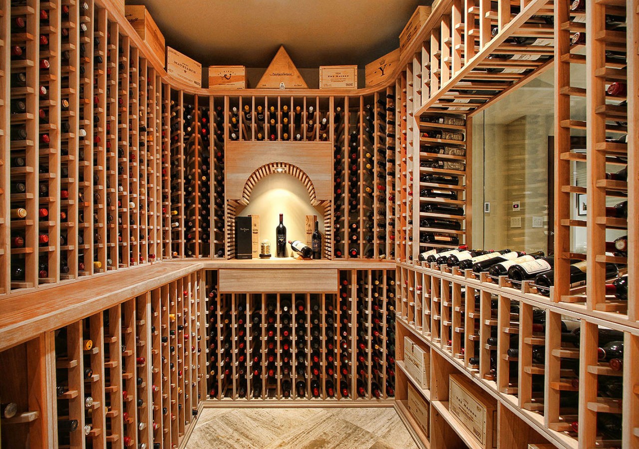 Interior of the wine cellar, featuring neatly organized shelves and soft ambient lighting.