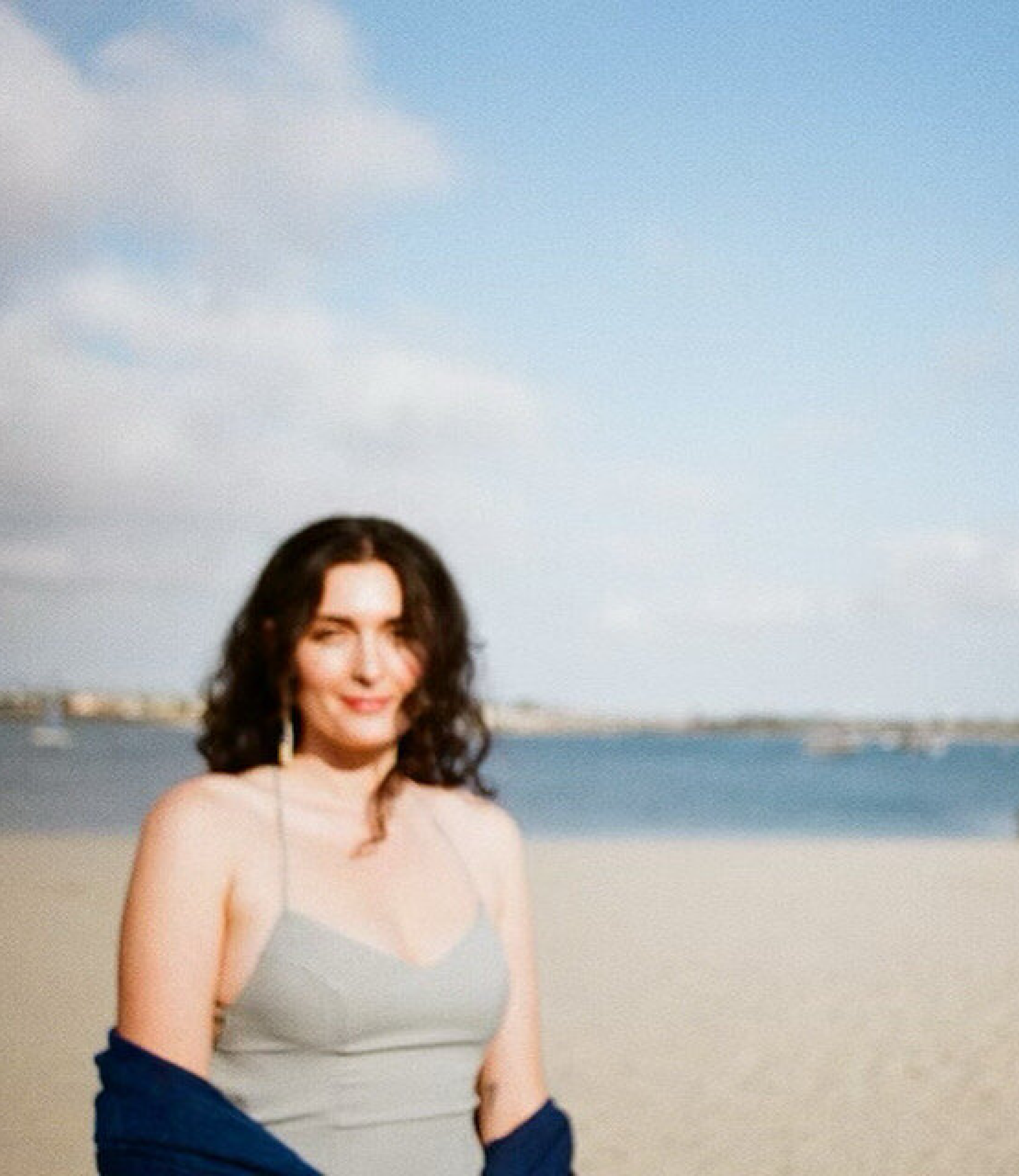 Rae Cohen in front of the bay in a seafoam dress