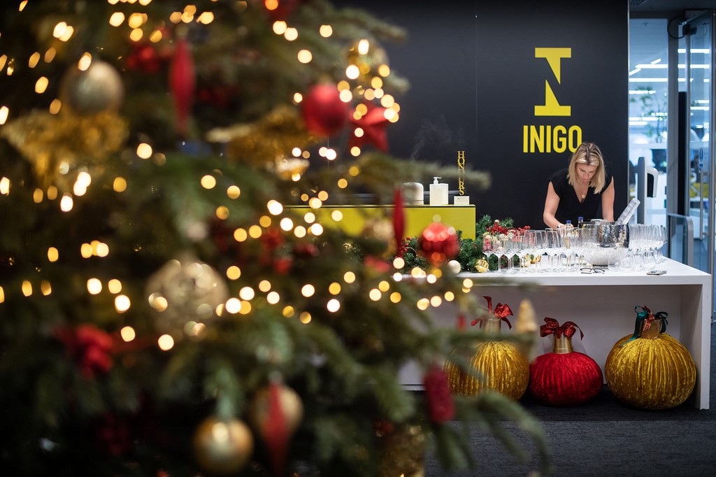 Guests enjoying holiday meal under fairy lights