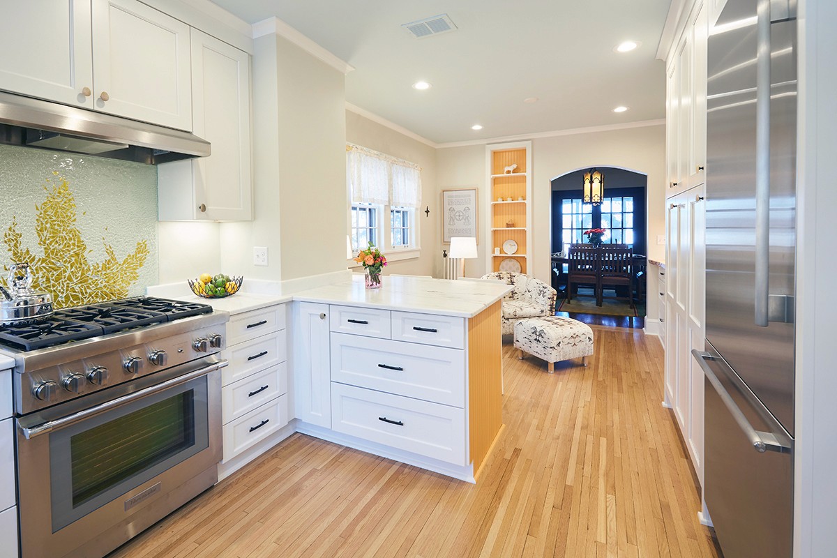 Stainless gas range with decorative gingko backsplash in the Linden Hills kitchen