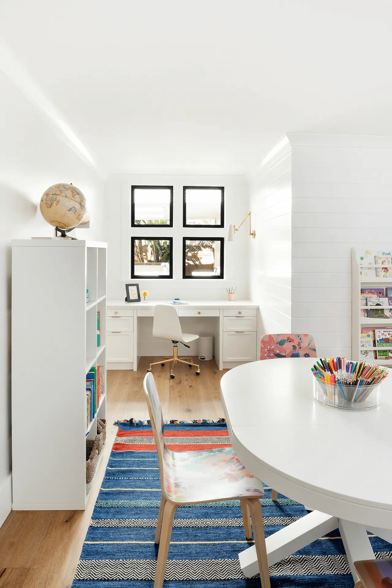 Bright and airy children’s study area with a white round table in North Tustin Remodel & Addition. Photo by Molly Rose.