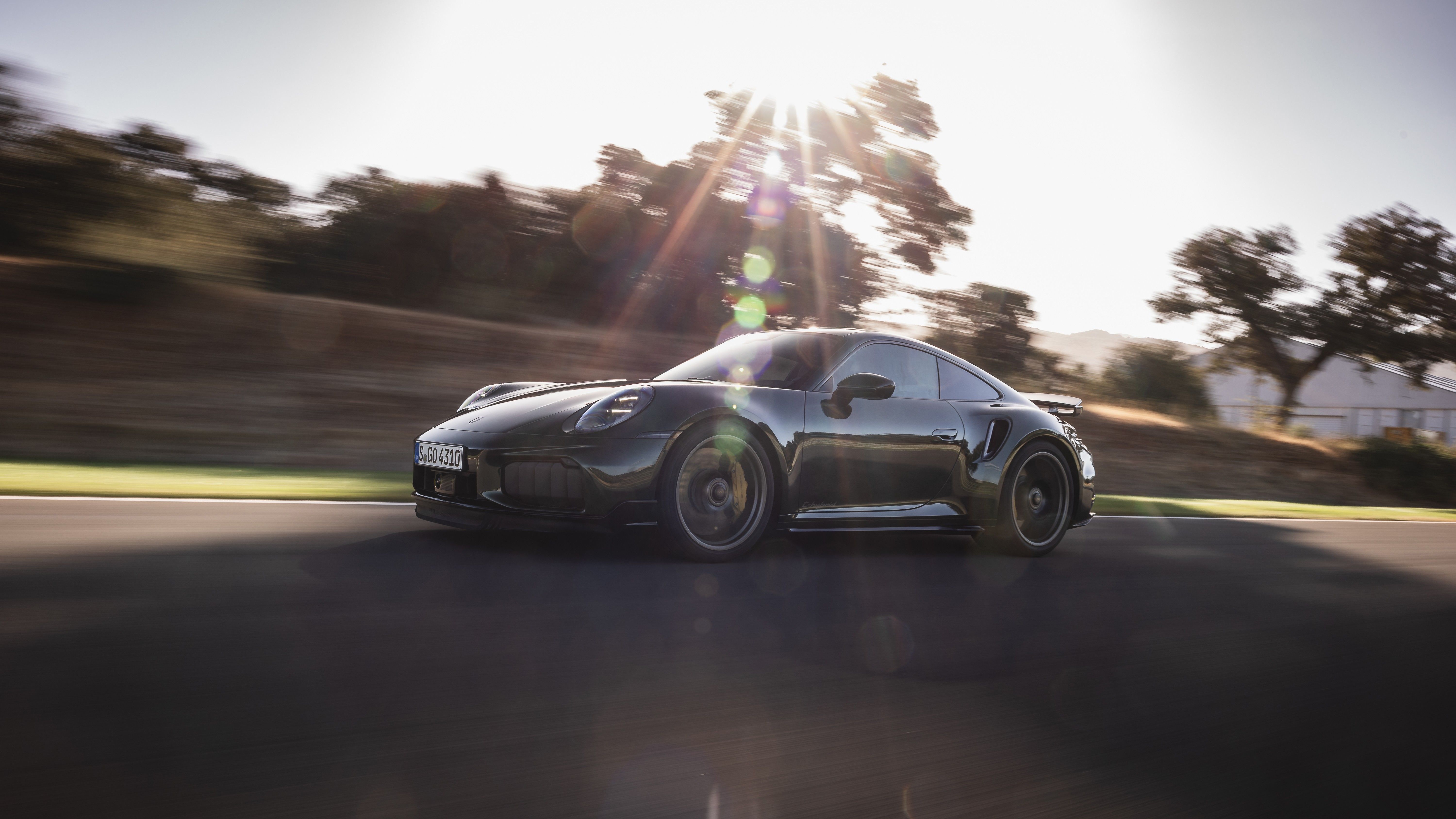 Porsche performance vehicle driving on the road