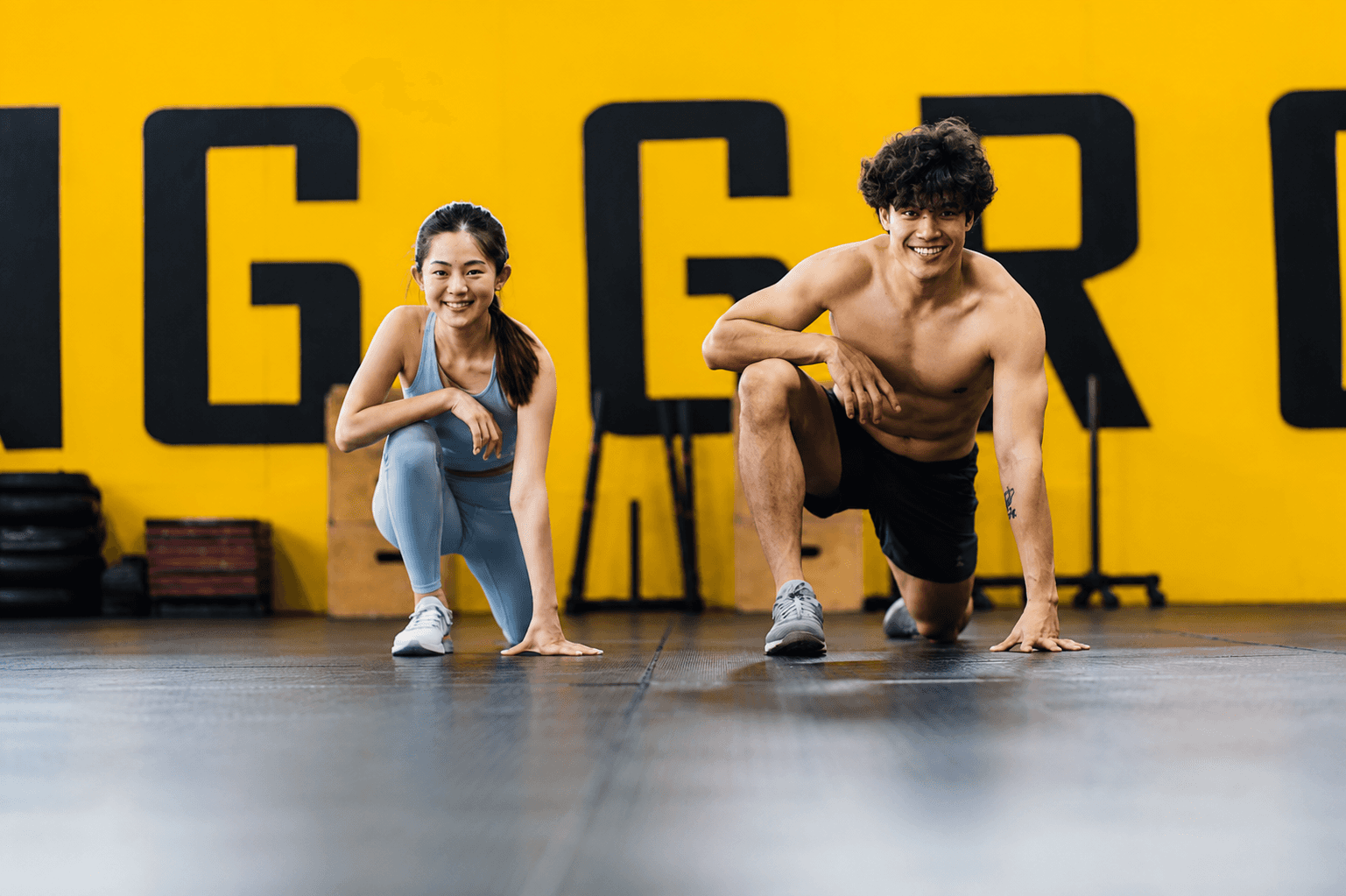 Two athletes exercising together to represent health beyond different body types