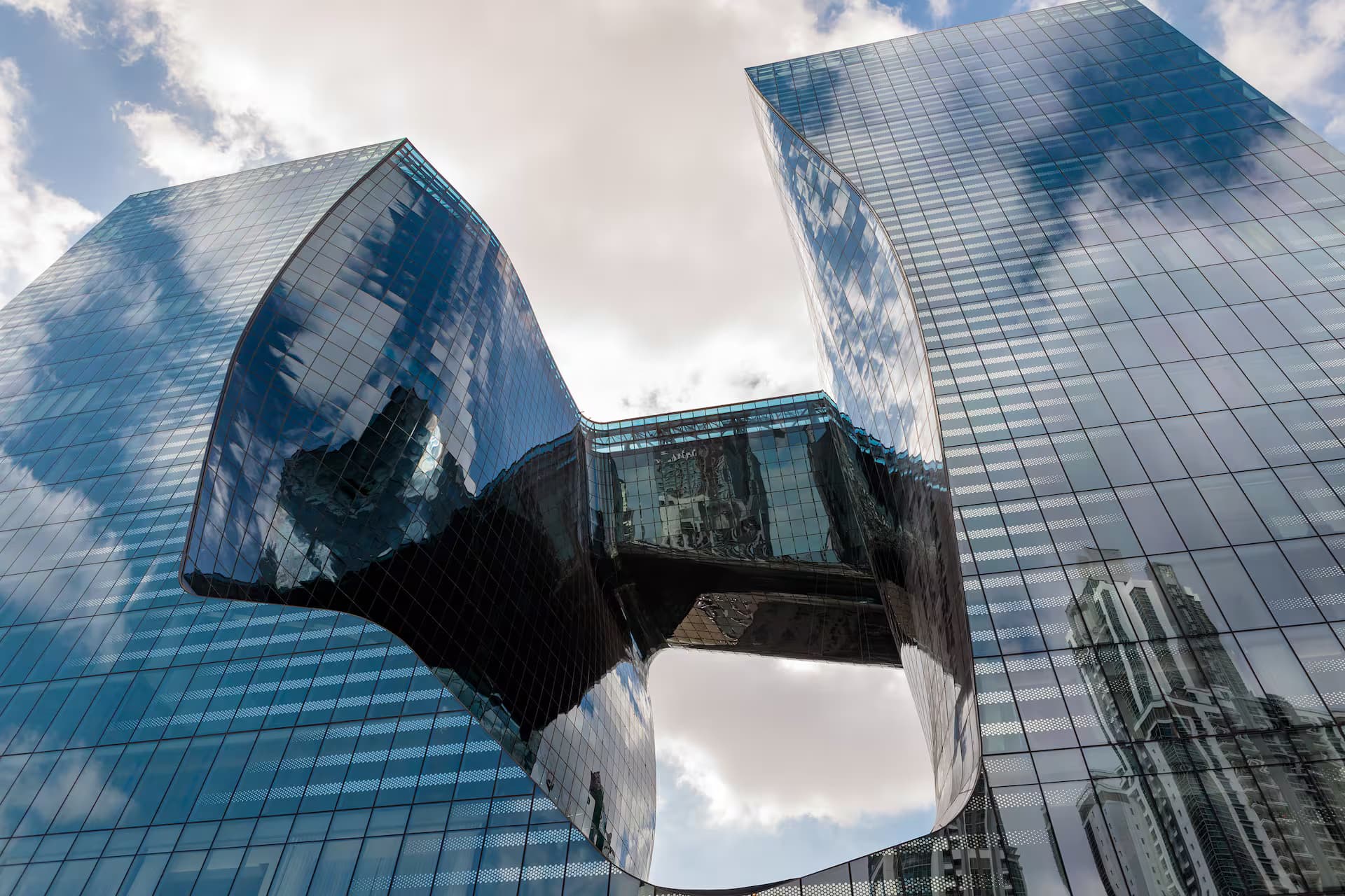 The exterior view of ME Dubai by Meliá, covered by glass windows and shaped in a unique design.