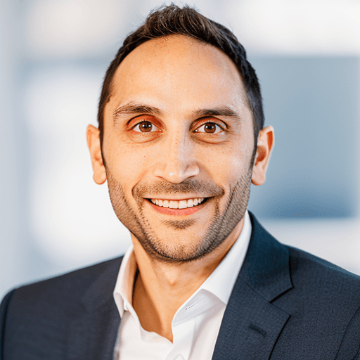 matt rebeiro in a suit looking happy