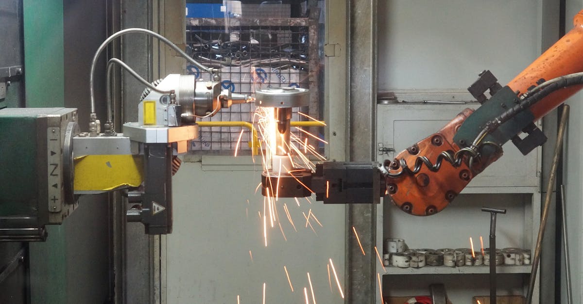 A robotic arm welding in an industrial setting, emitting bright sparks.