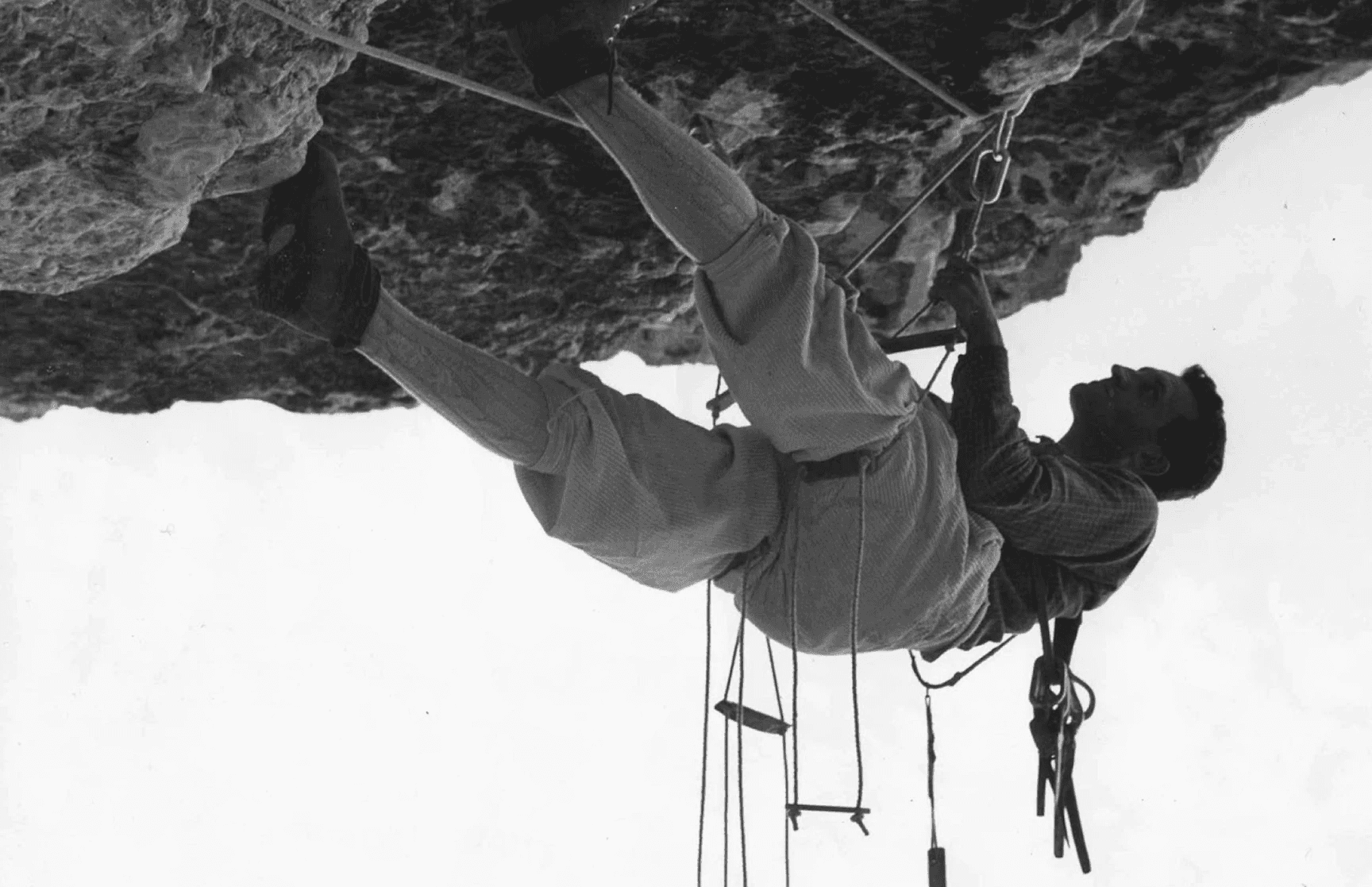 Mountain man scaling a mountain horizontally