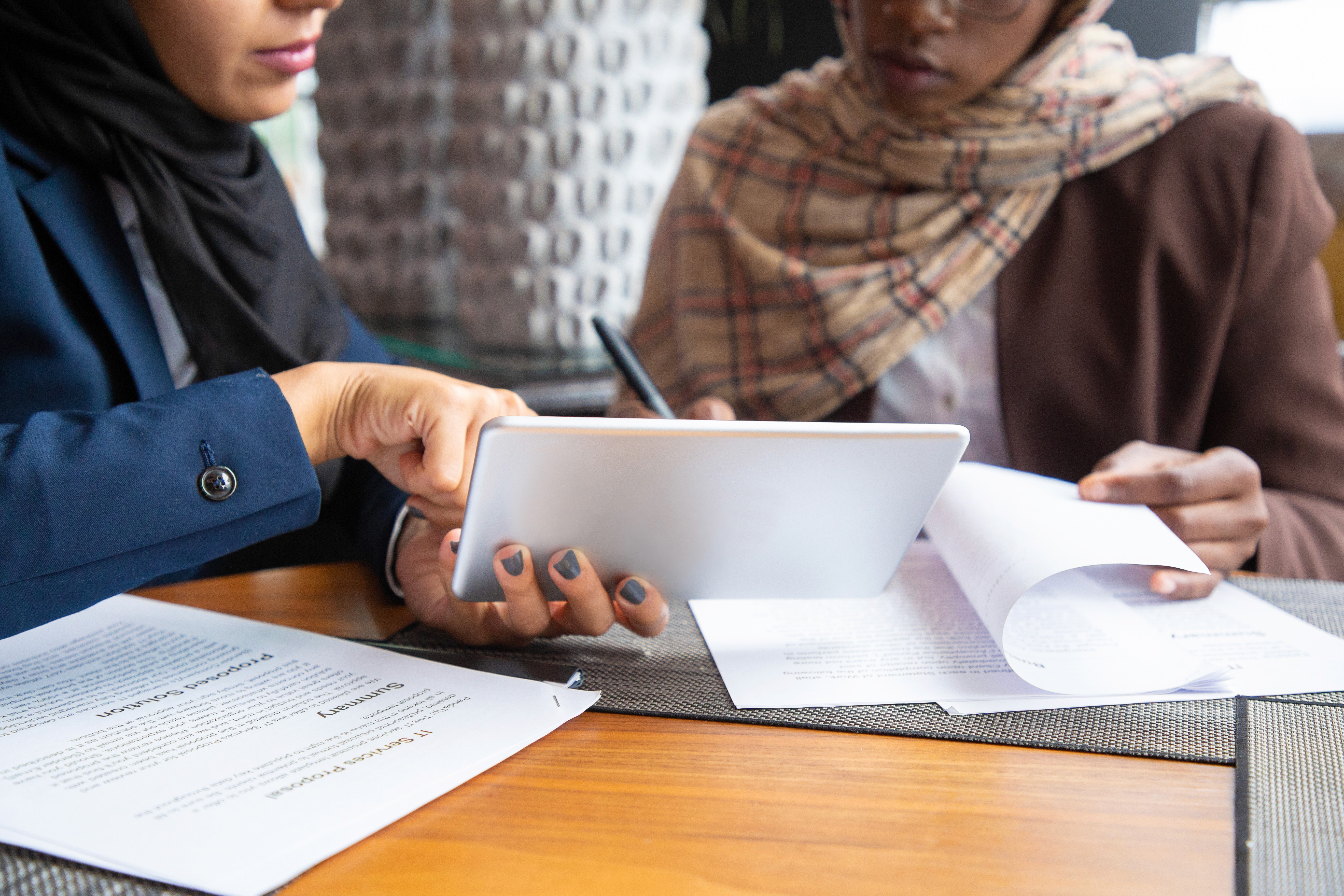 Two professionals reviewing documents to discuss the requirements for opening a bank account for non-residents in the UAE.