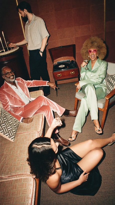 Friends in a velvet lounge with a record player