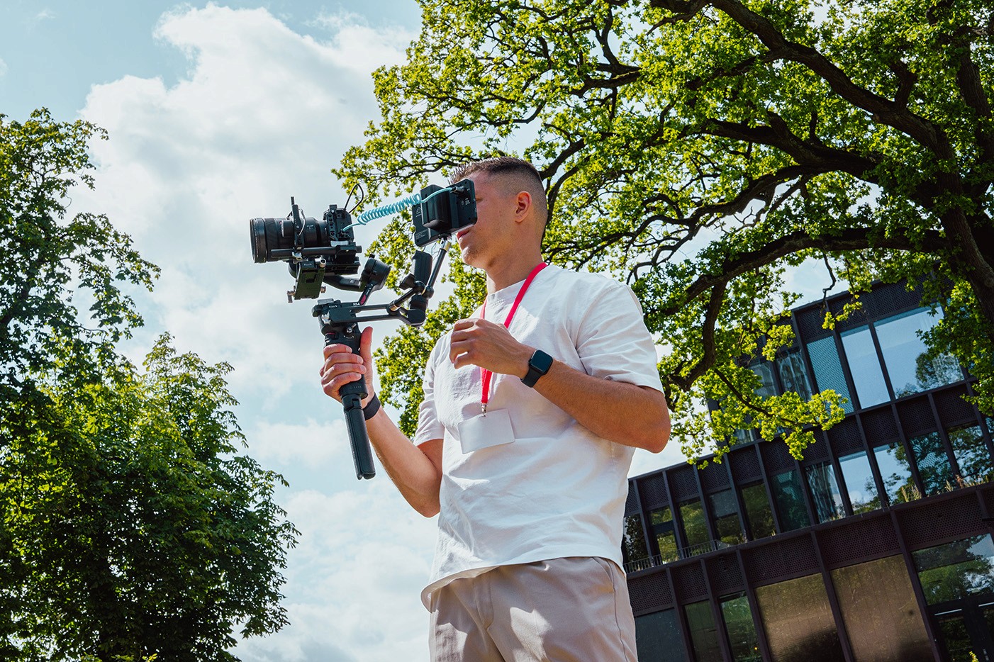Person, holding a white rose behind his back with one arm on a light blue background