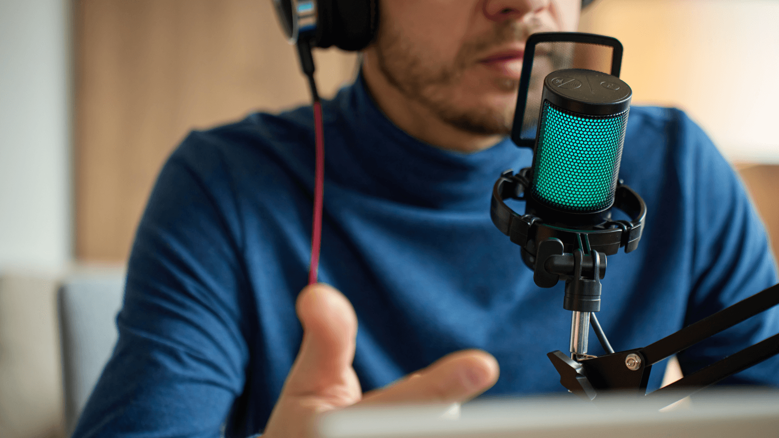 Host speaking into a studio microphone while recording a podcast