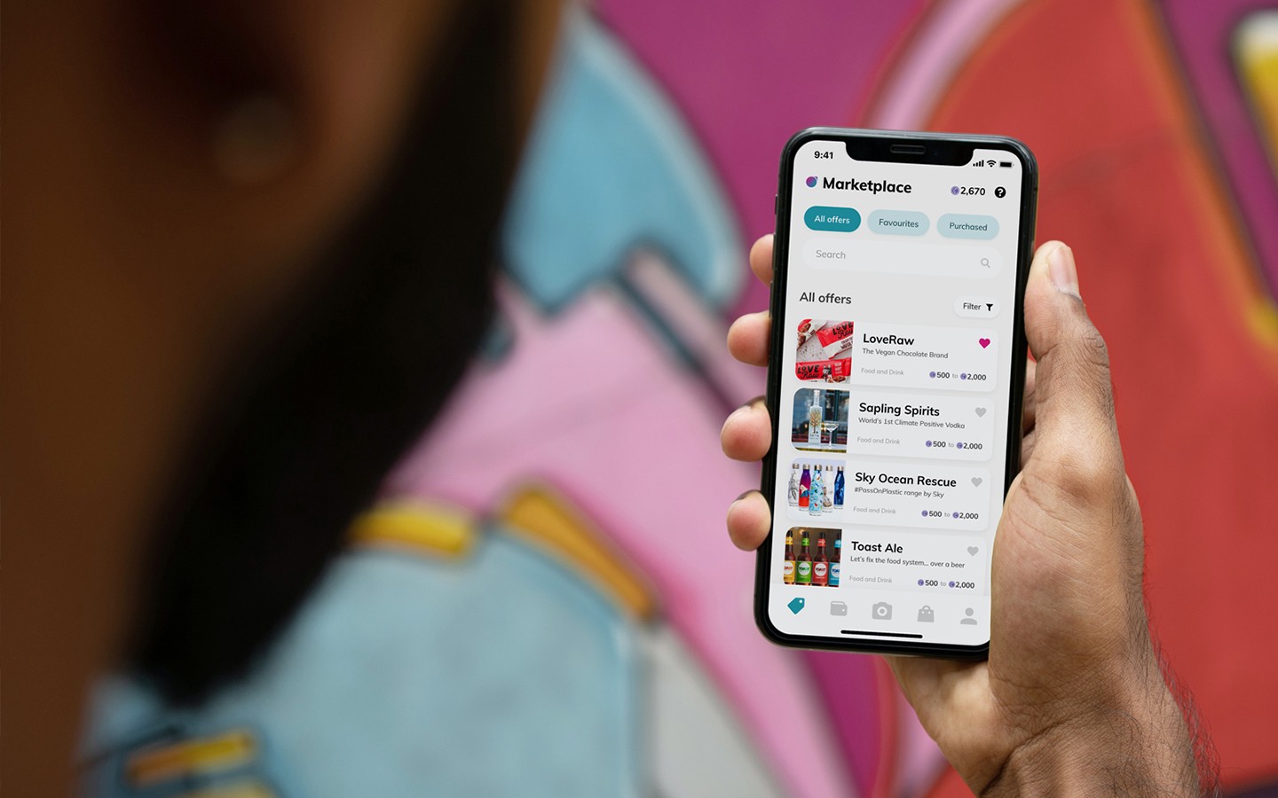 Hand holding phone displaying the Bagboard app’s Marketplace screen where you can purchase vouchers