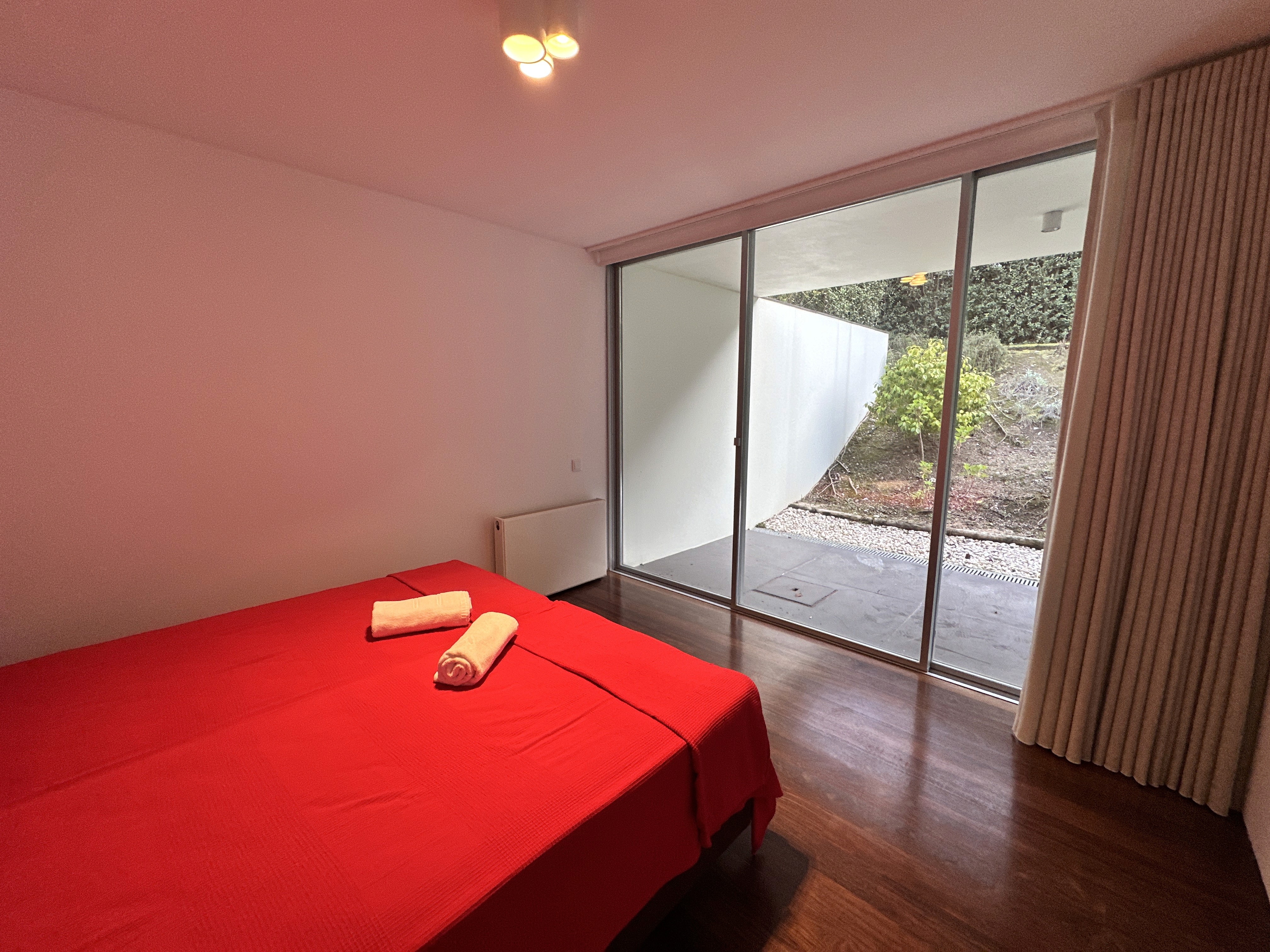 Dining area with red chairs and a view of the living room