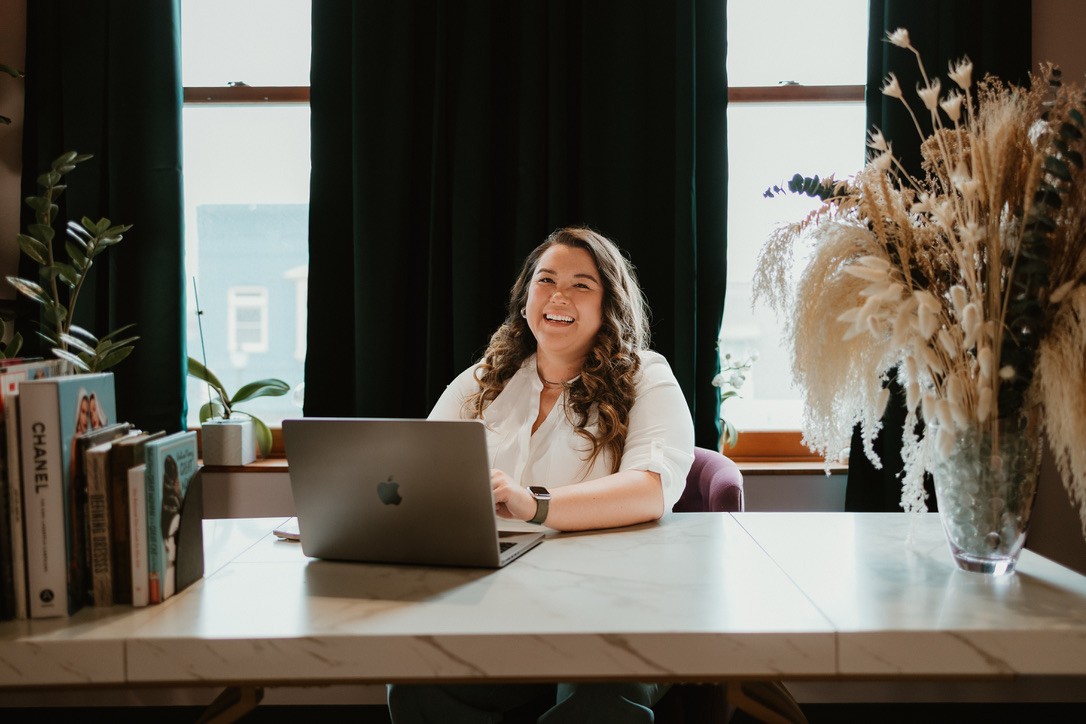 Woman Siting at laptop texting 