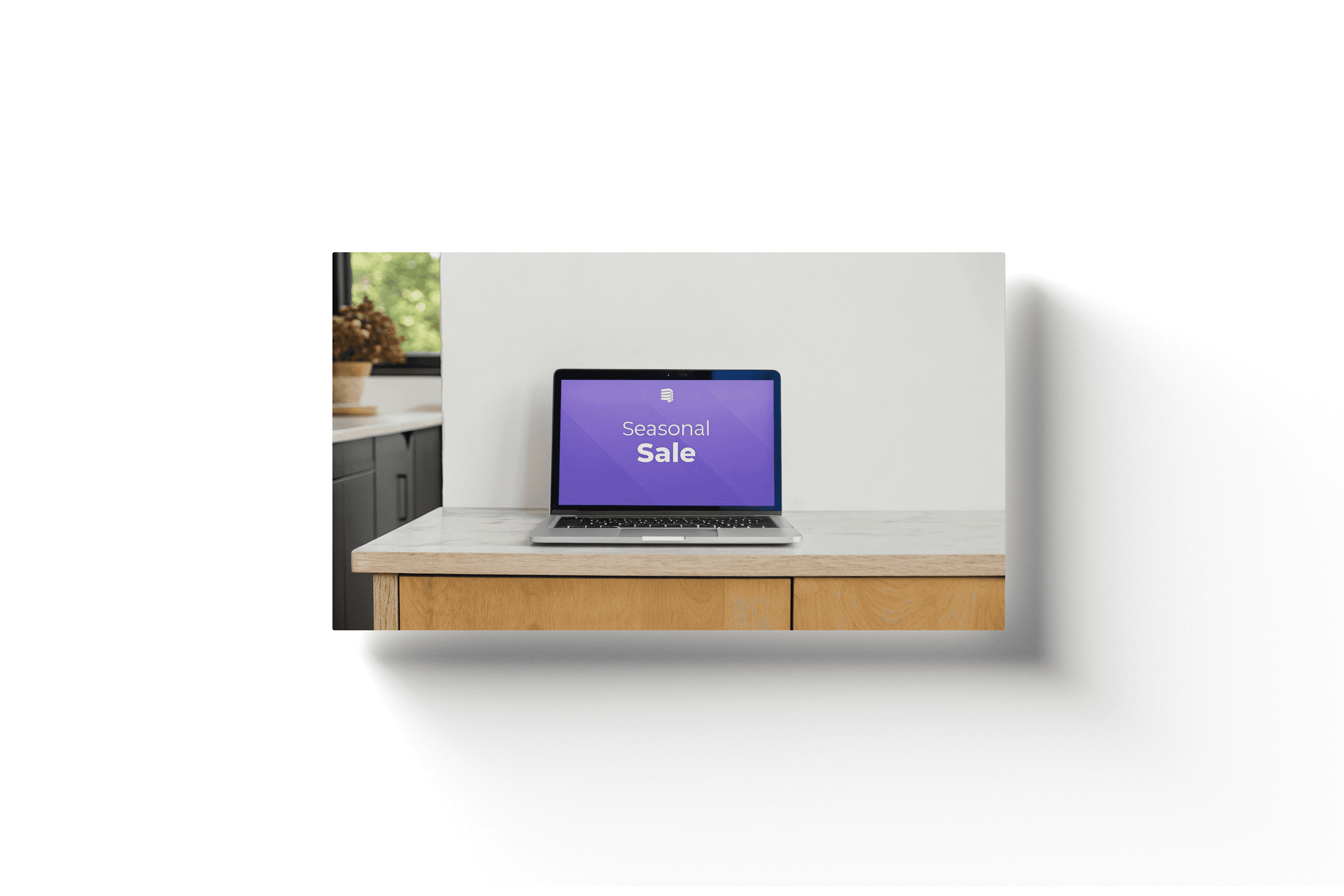 a laptop with a purple screen on a white countertop