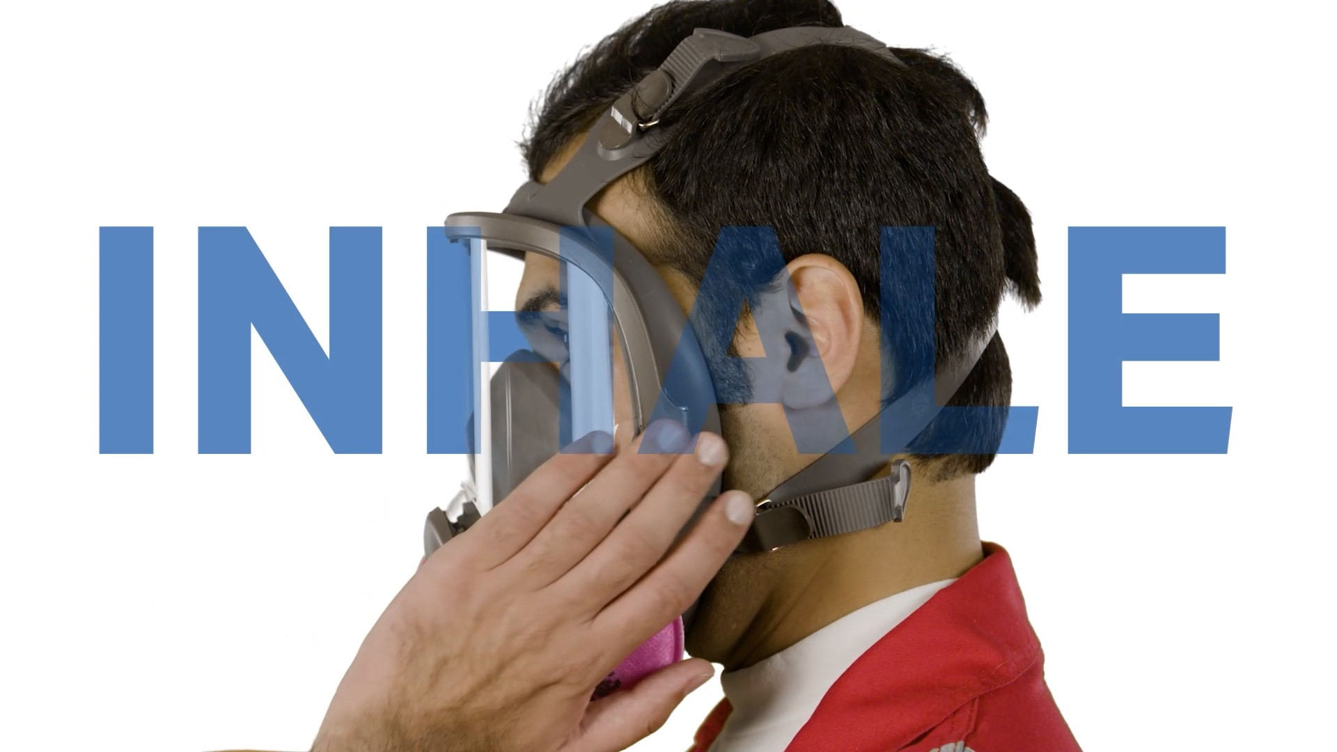 Side view of man's head equipping a gas mask with inhale label