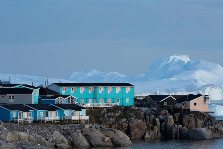 sunloungers fronting buildings near mountain