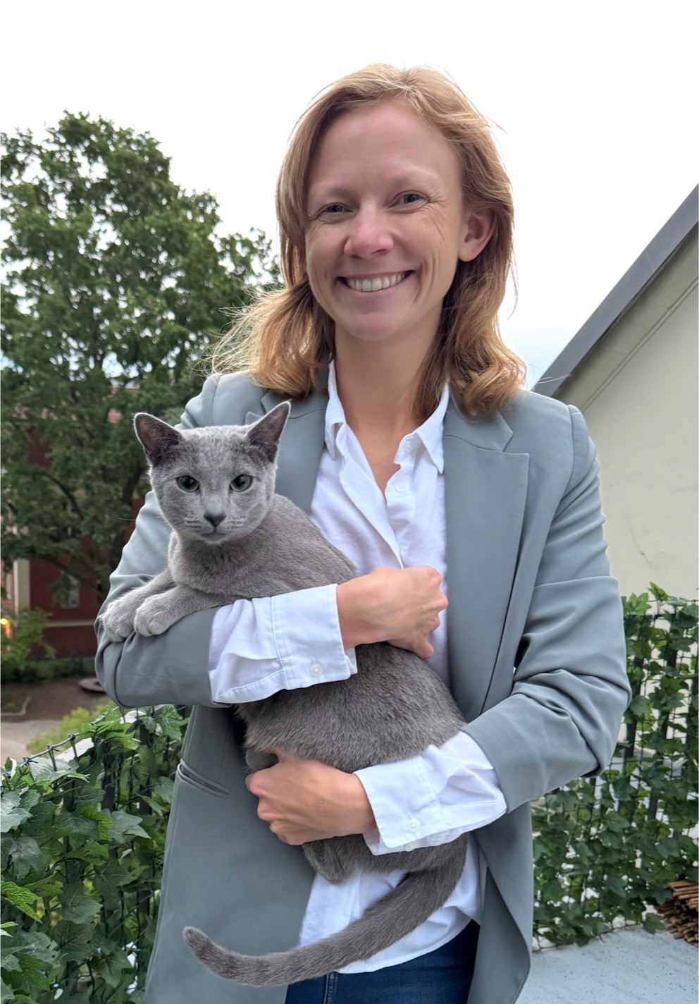 Portrait of a person in dark clothing speaking on a phone