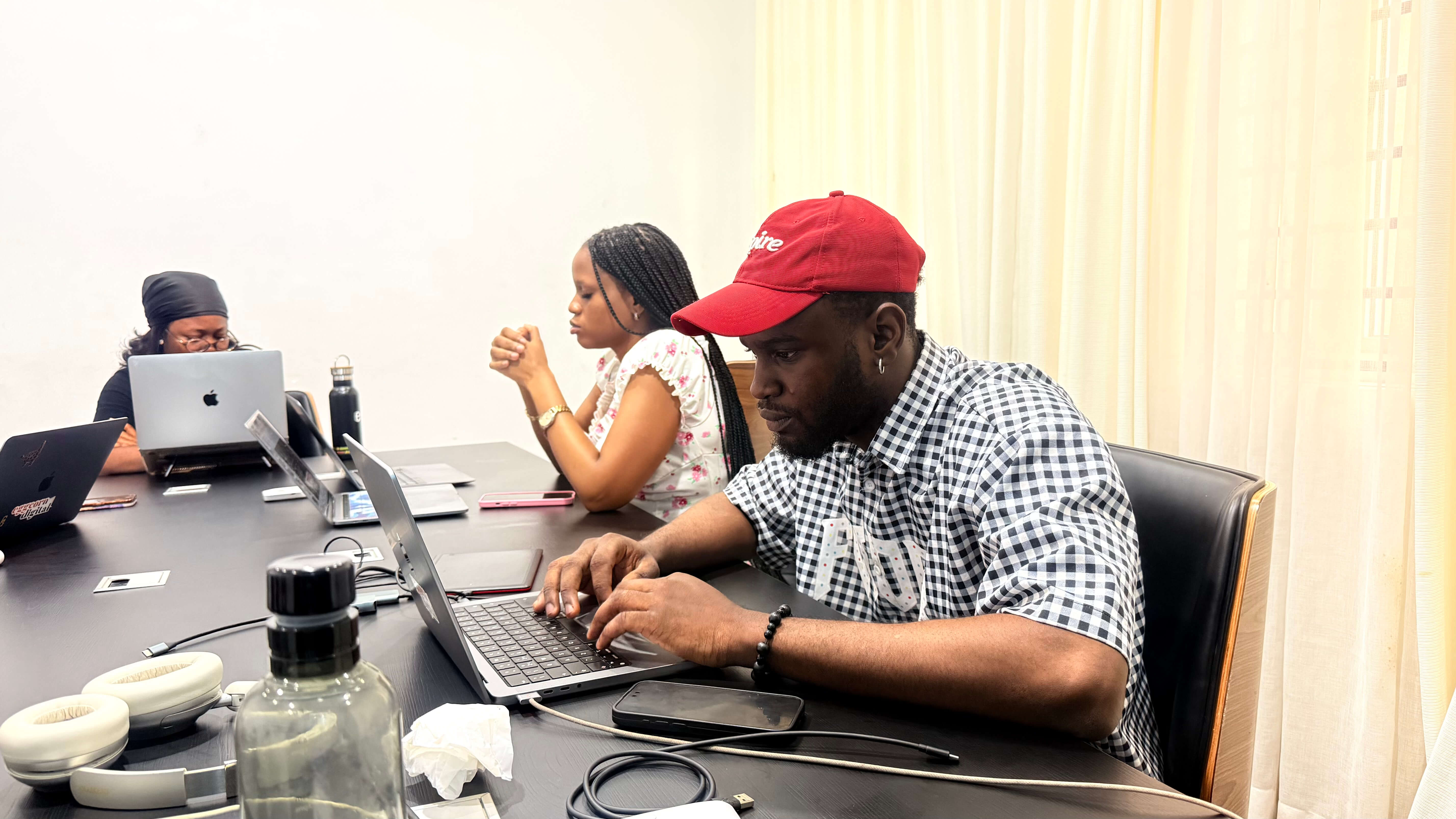 Young black woman witting at the table working on a laptop