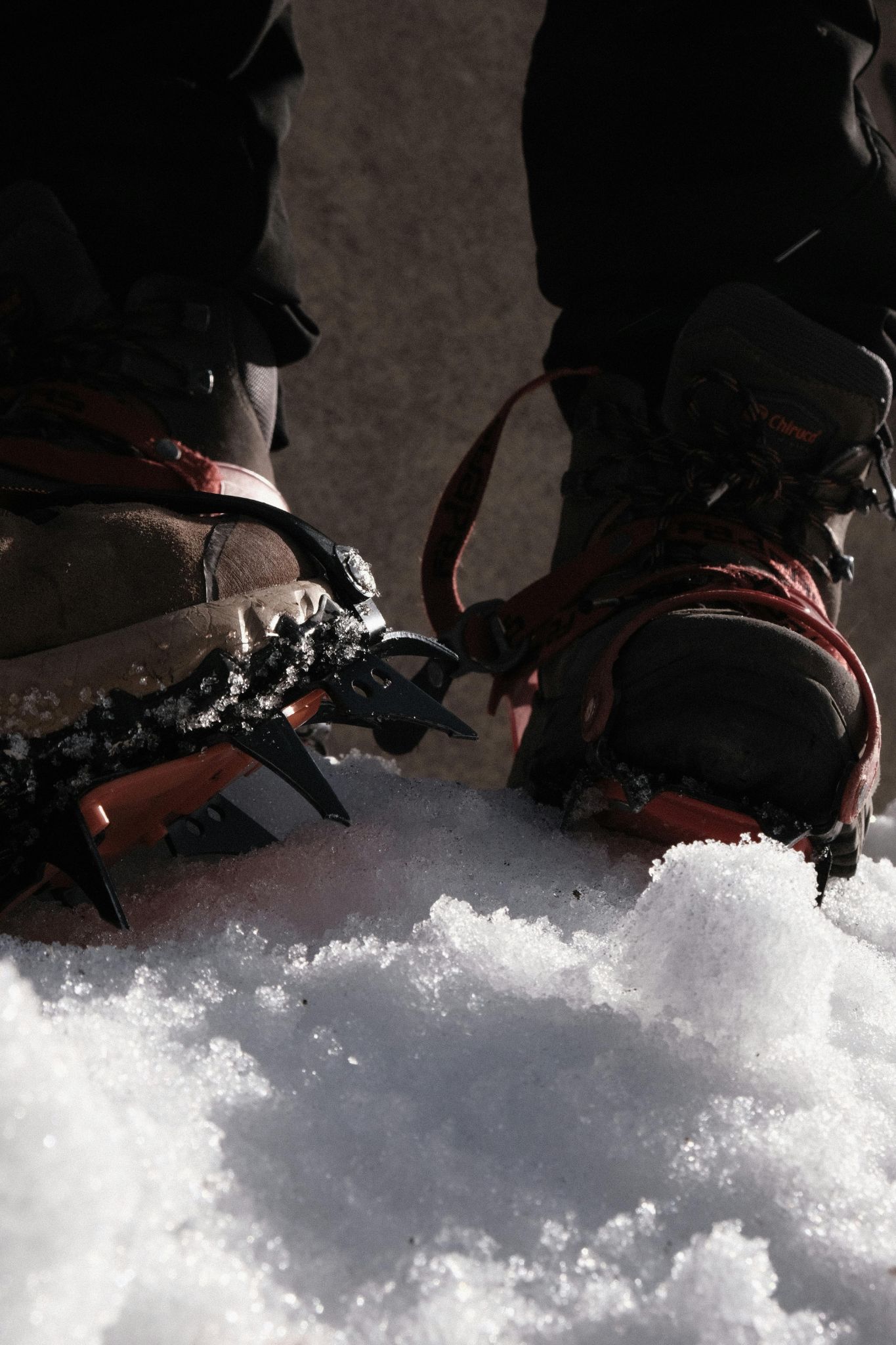 Man scaling mountain in snow