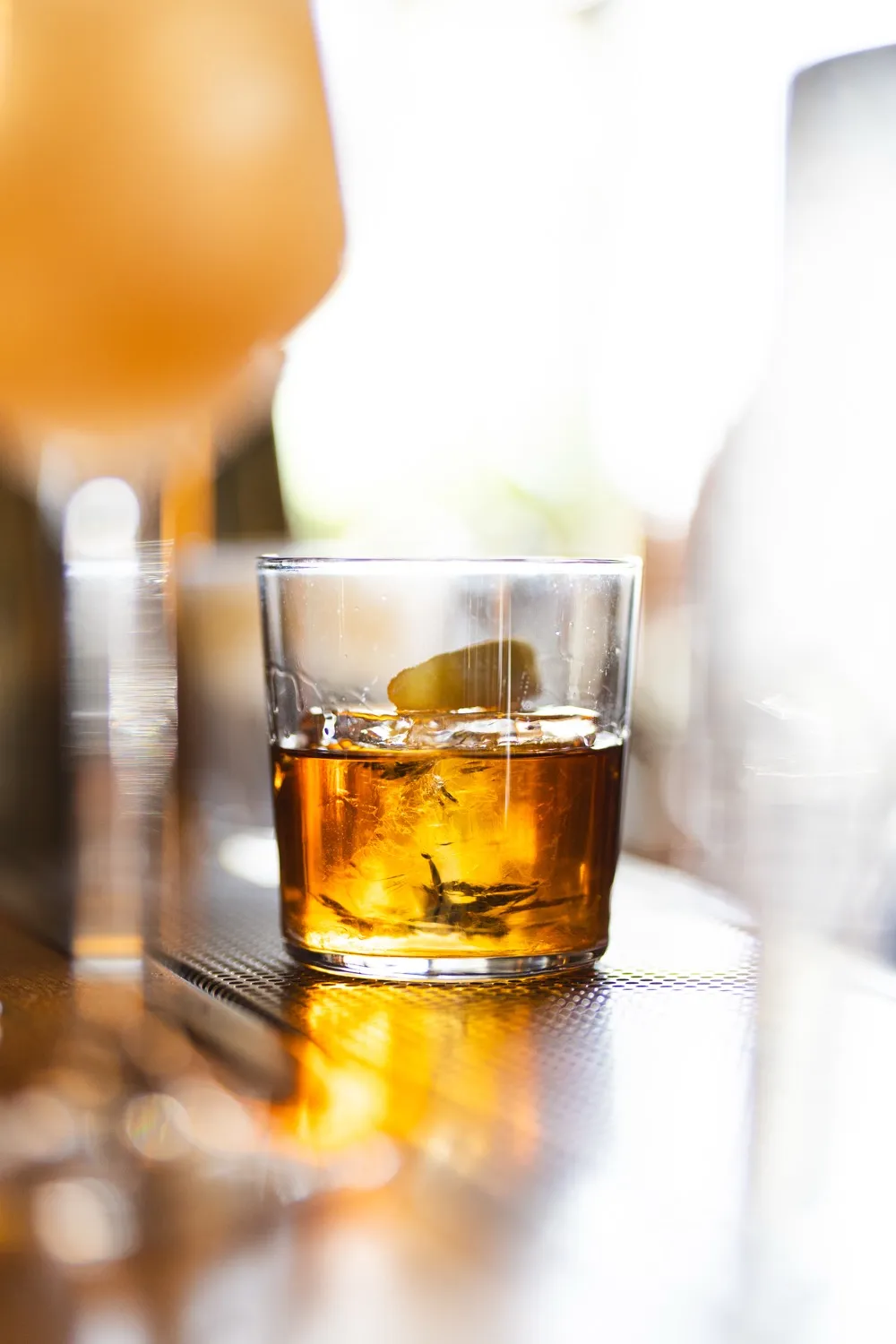 A phone, pad, and pen sit on a wooden desk.