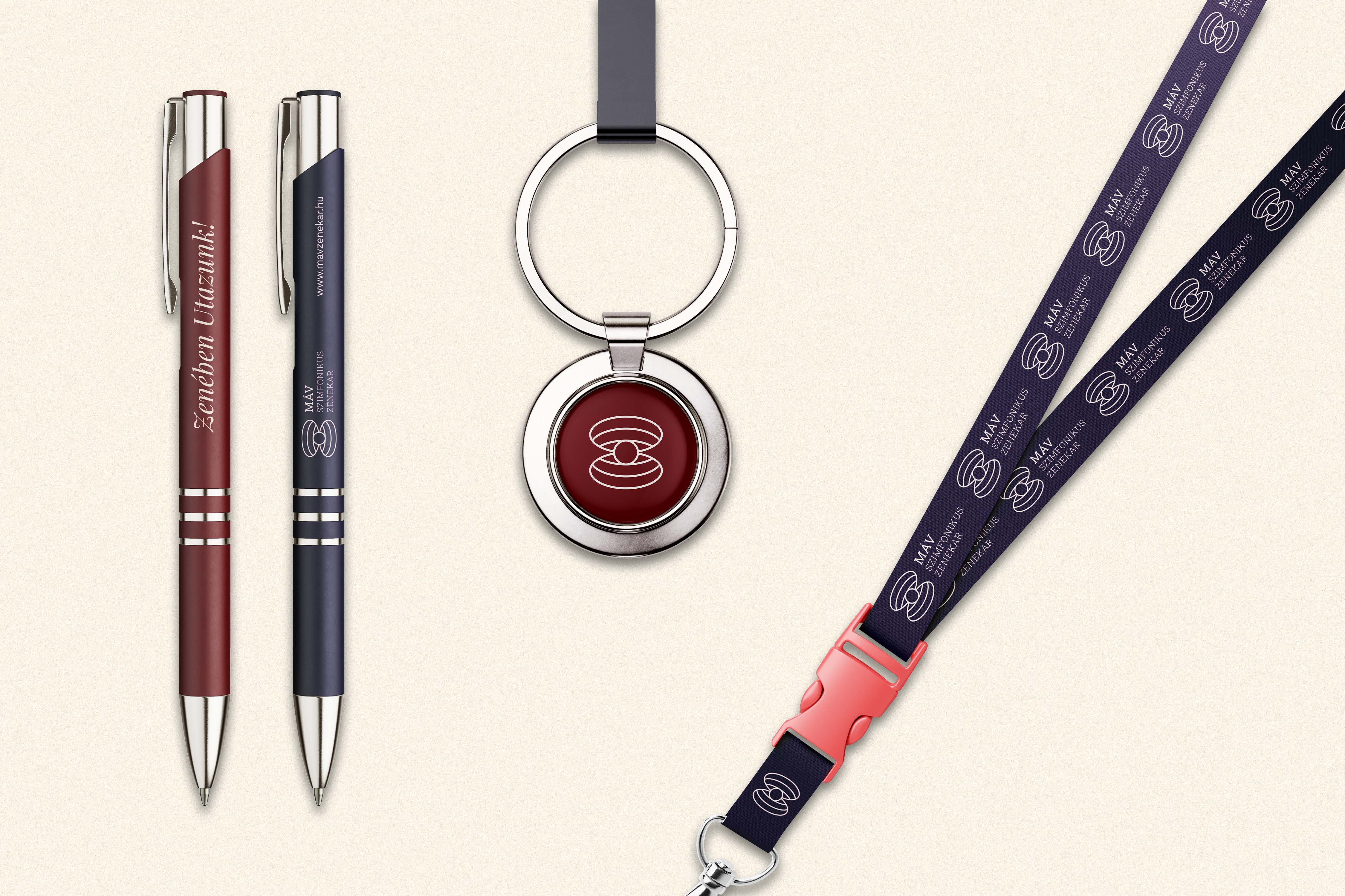 Branded pens, metal keychain and lanyard featuring the V1 logo in red and purple - MÁV Symphony Orchestra, a symphony orchestra brand identity.