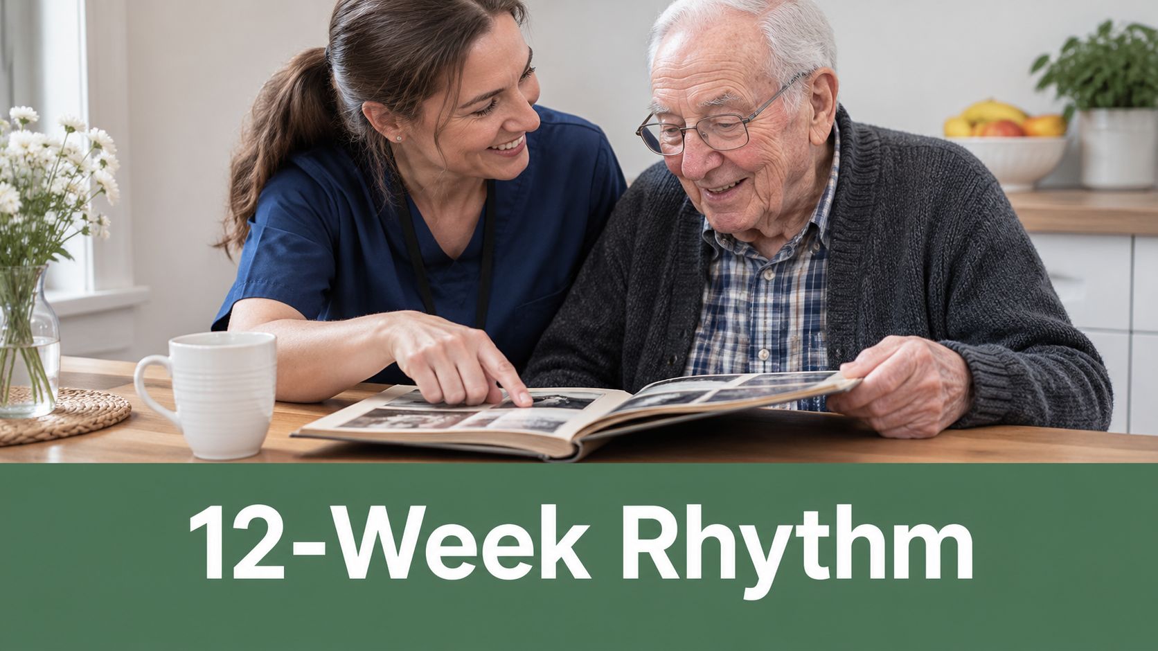 A caregiver looking at a photo album with an elderly man sitting at a wooden kitchen table.