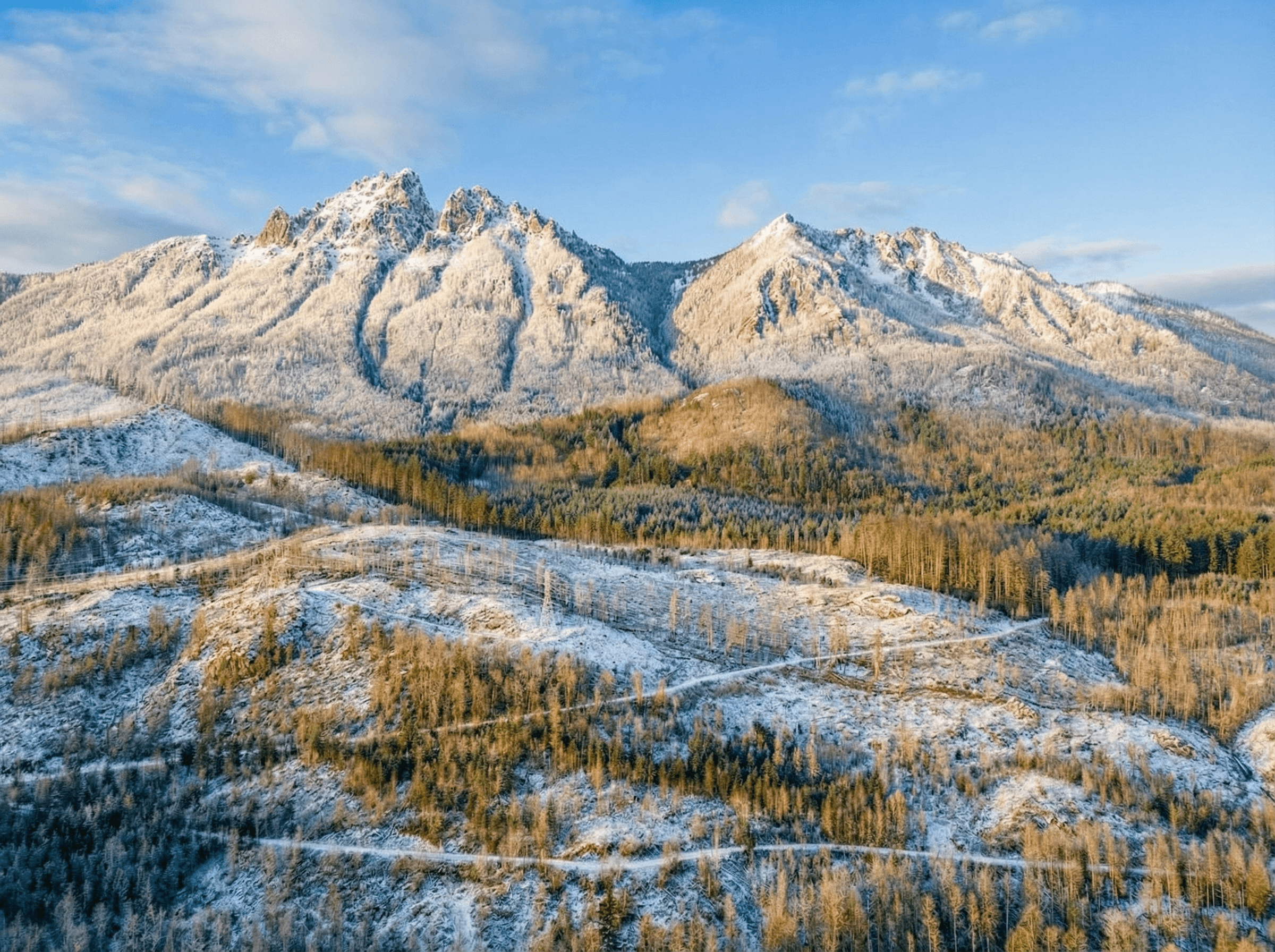 A large, dark futuristic spaceship flying over a glowing city at sunset