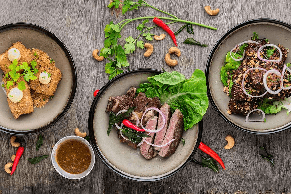 Why Everyone Needs Protein. Yes, Even You steak salad and fish on table