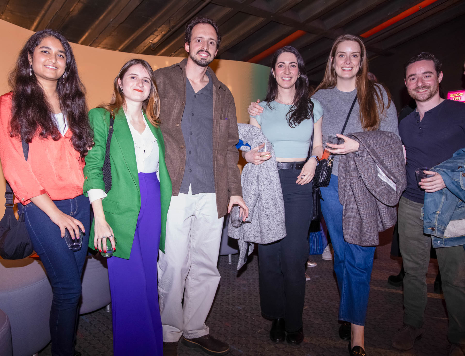 a group of students smiling for the camera in the SVA Theatre lobby after the Venture Forum