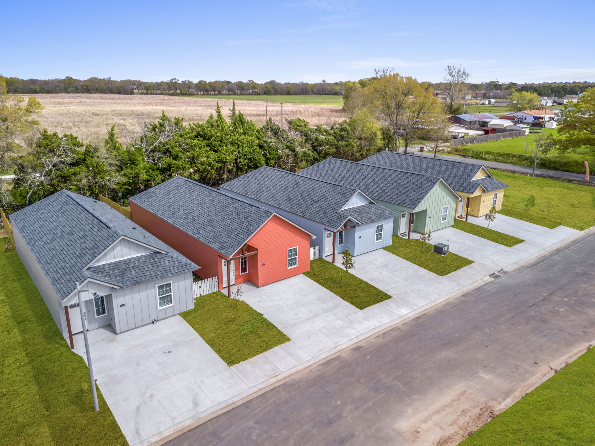 A modern kitchen featuring a bar stool beside a sleek refrigerator, showcasing a clean and organized space.