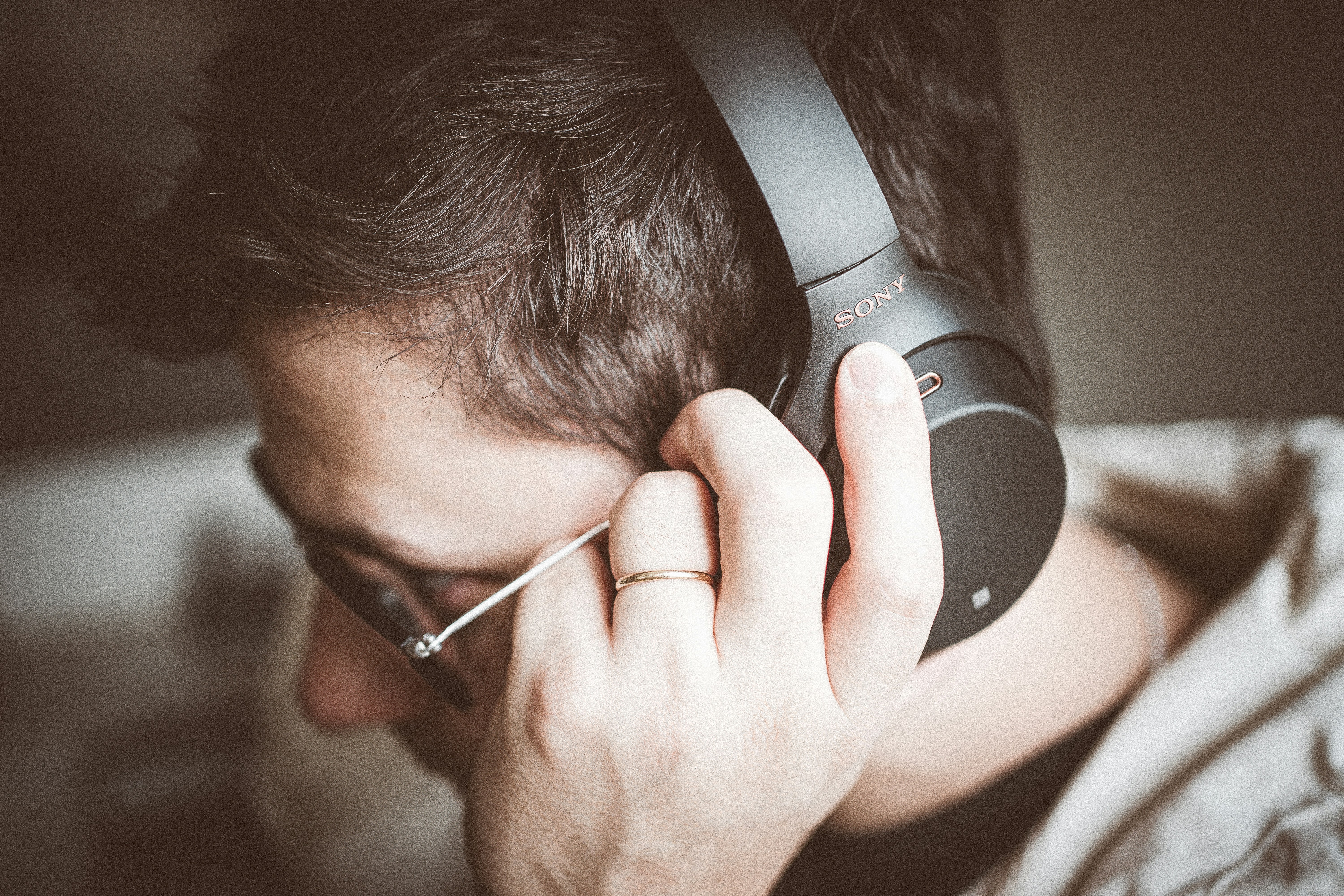 man using headphones - Remove Background Noise from Audio