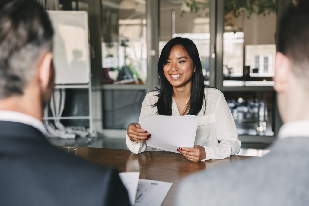 Woman smiling in a job interview.