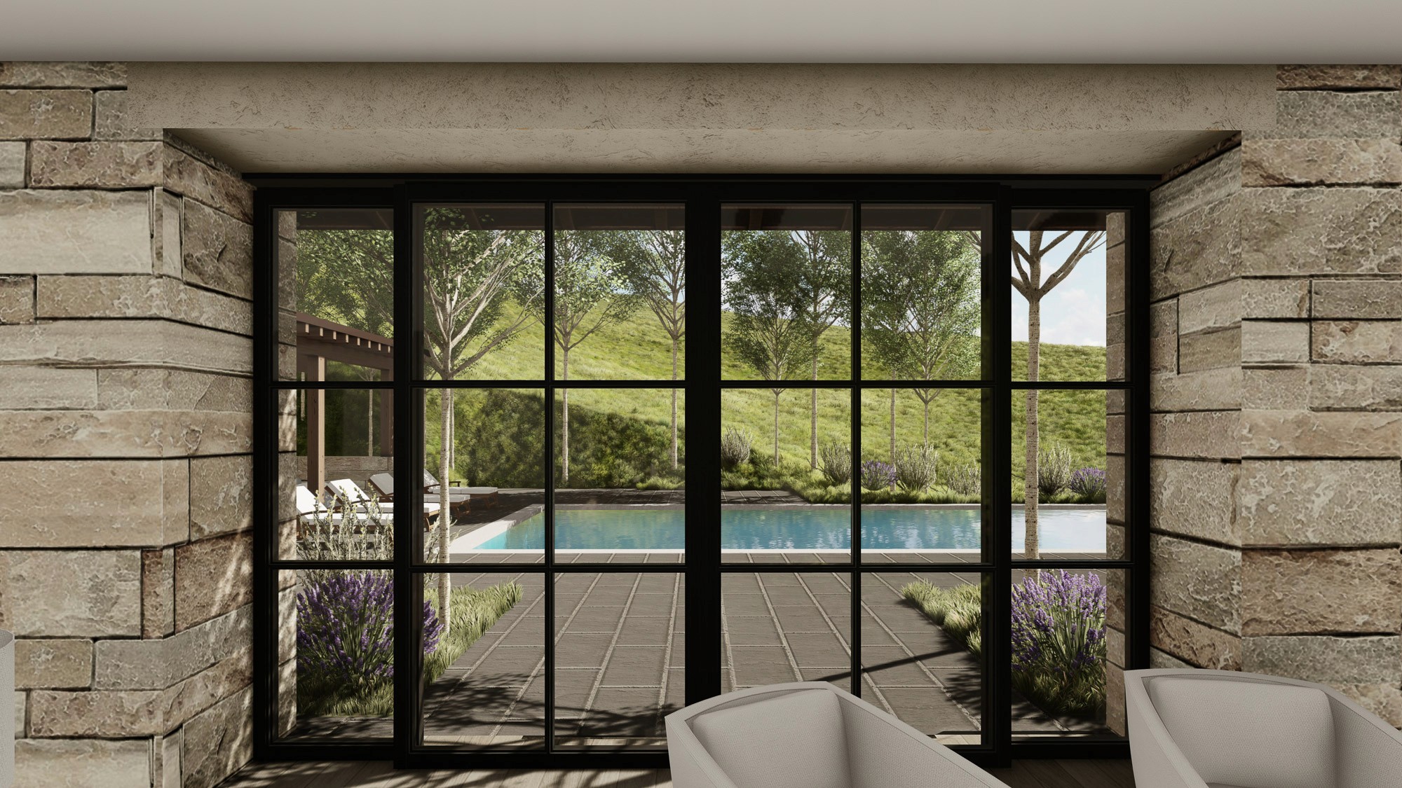 Sliding glass doors opening to a patio and pool with a grassy hill background.
