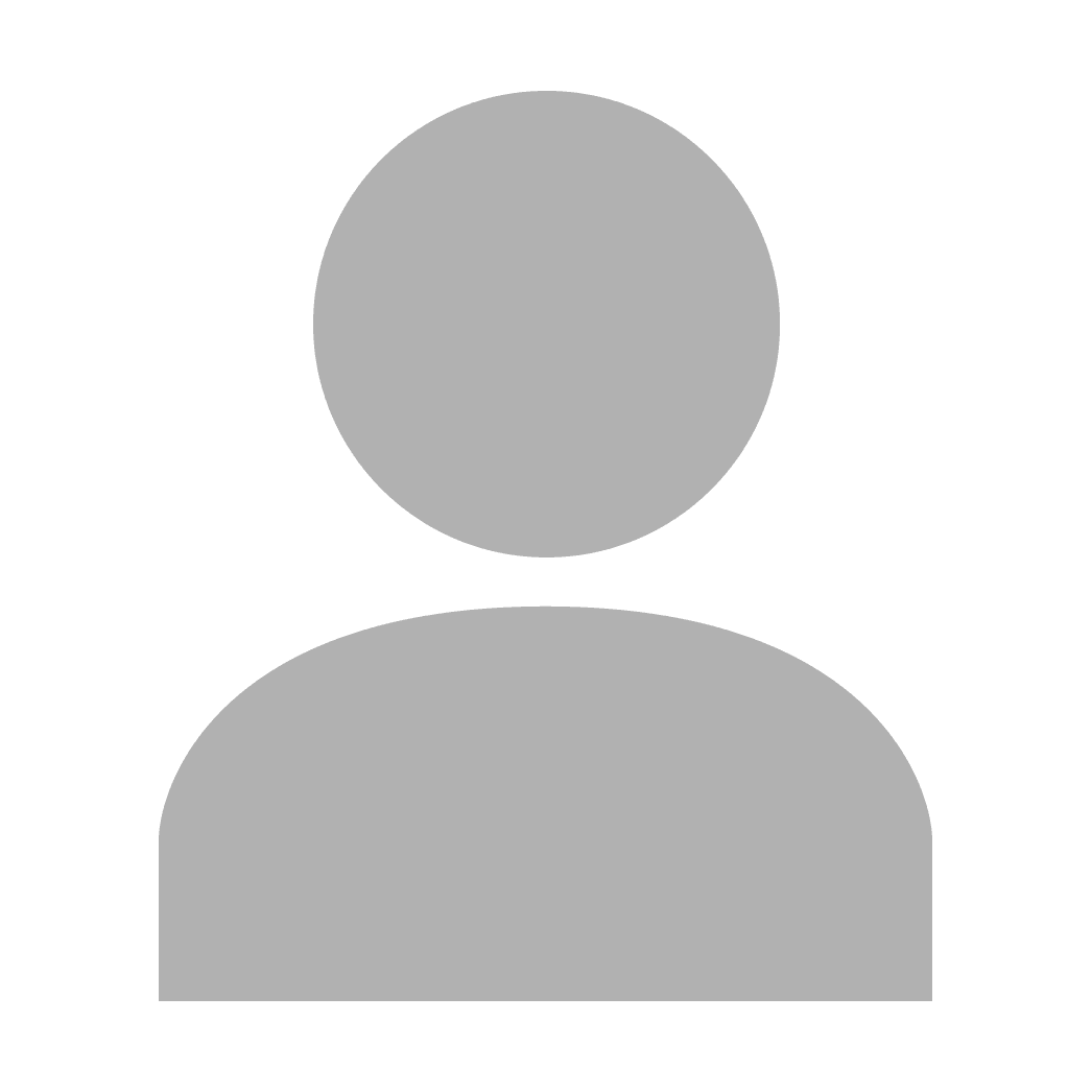 Portrait of a person in a pink sweater against a light background