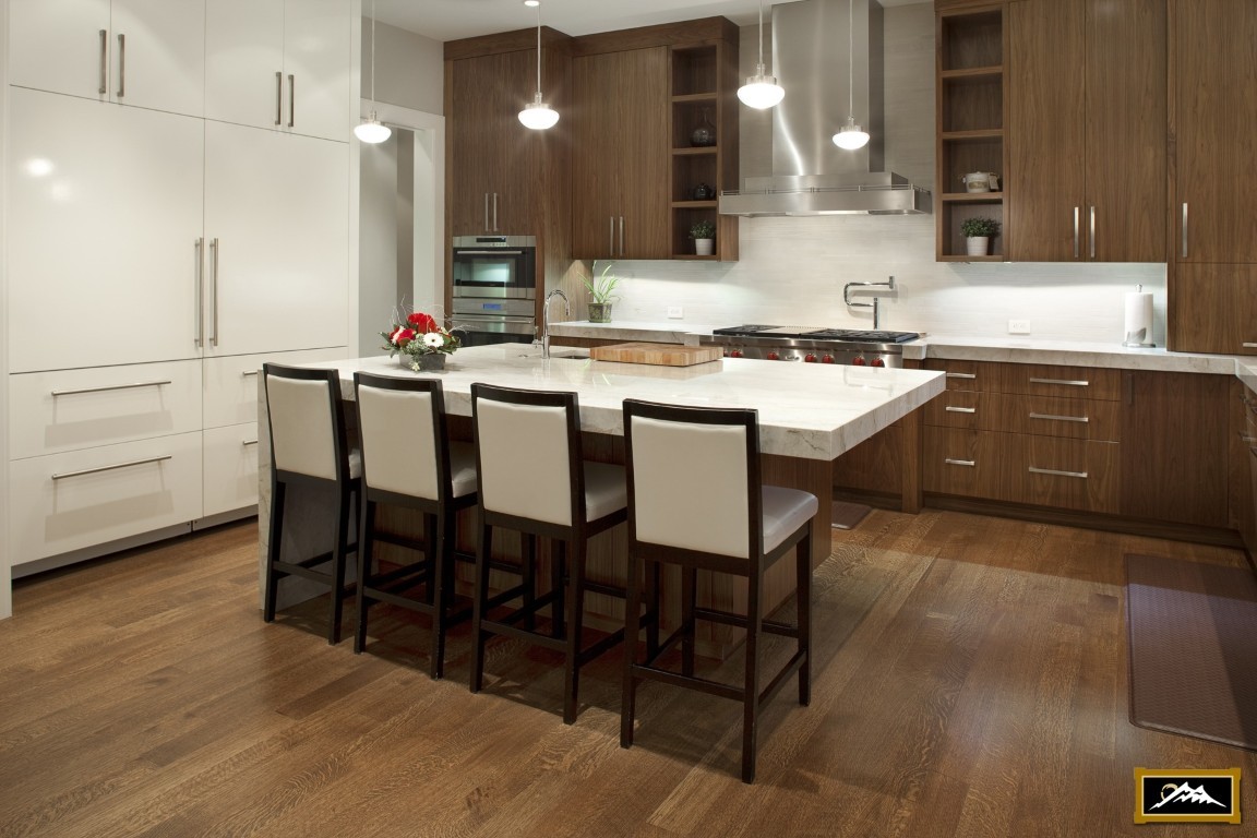 Image of Modern kitchen design with island, marble countertop, and stools, showcasing KHD Homes' layout and interior design expertise.