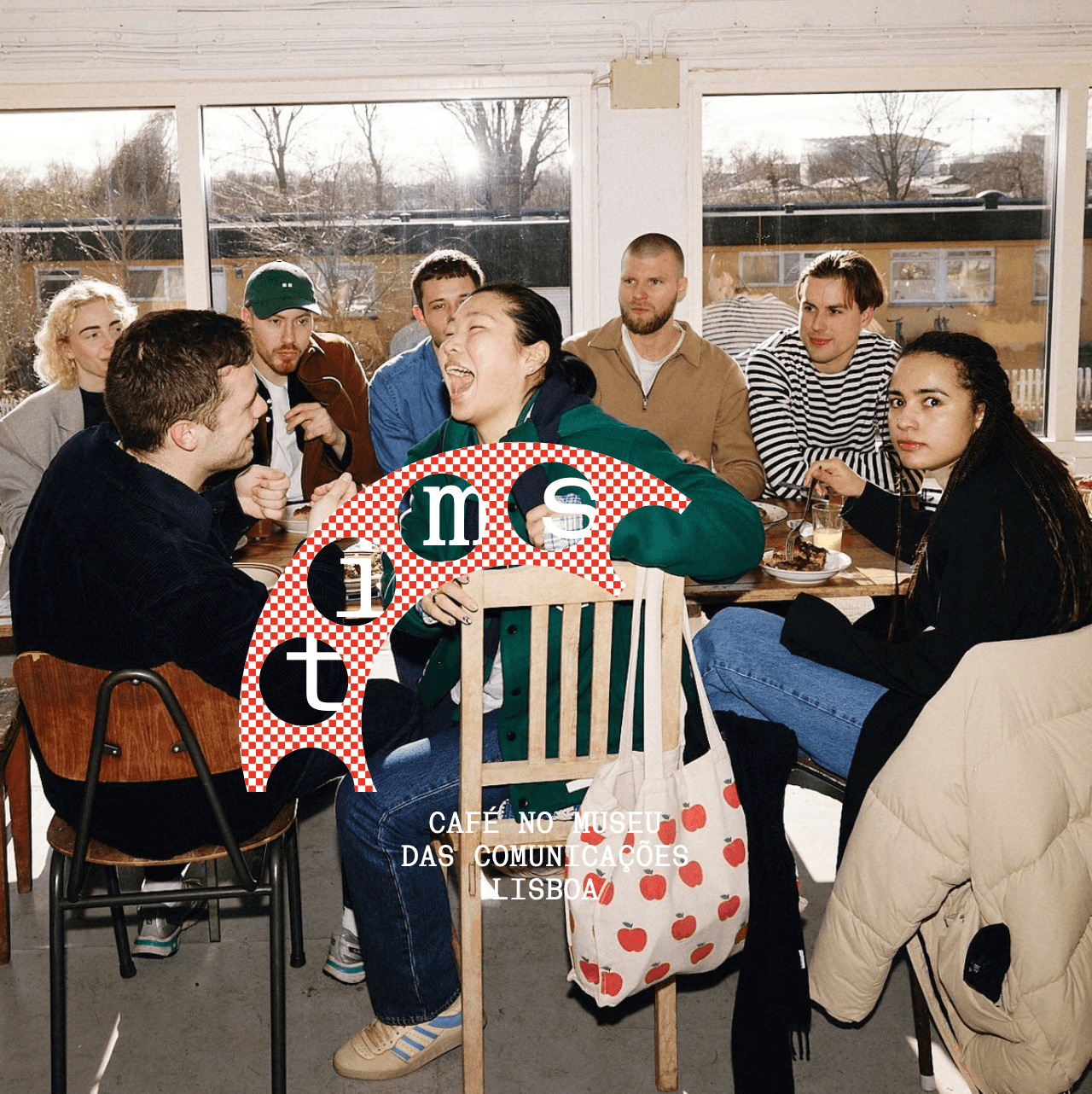Person wearing a beige apron whisking green matcha tea in a ceramic bowl on a kitchen counter.