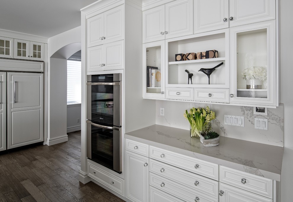 Image of Luxury kitchen design with white cabinetry, marble countertops, and stainless steel appliances by KHD Homes.