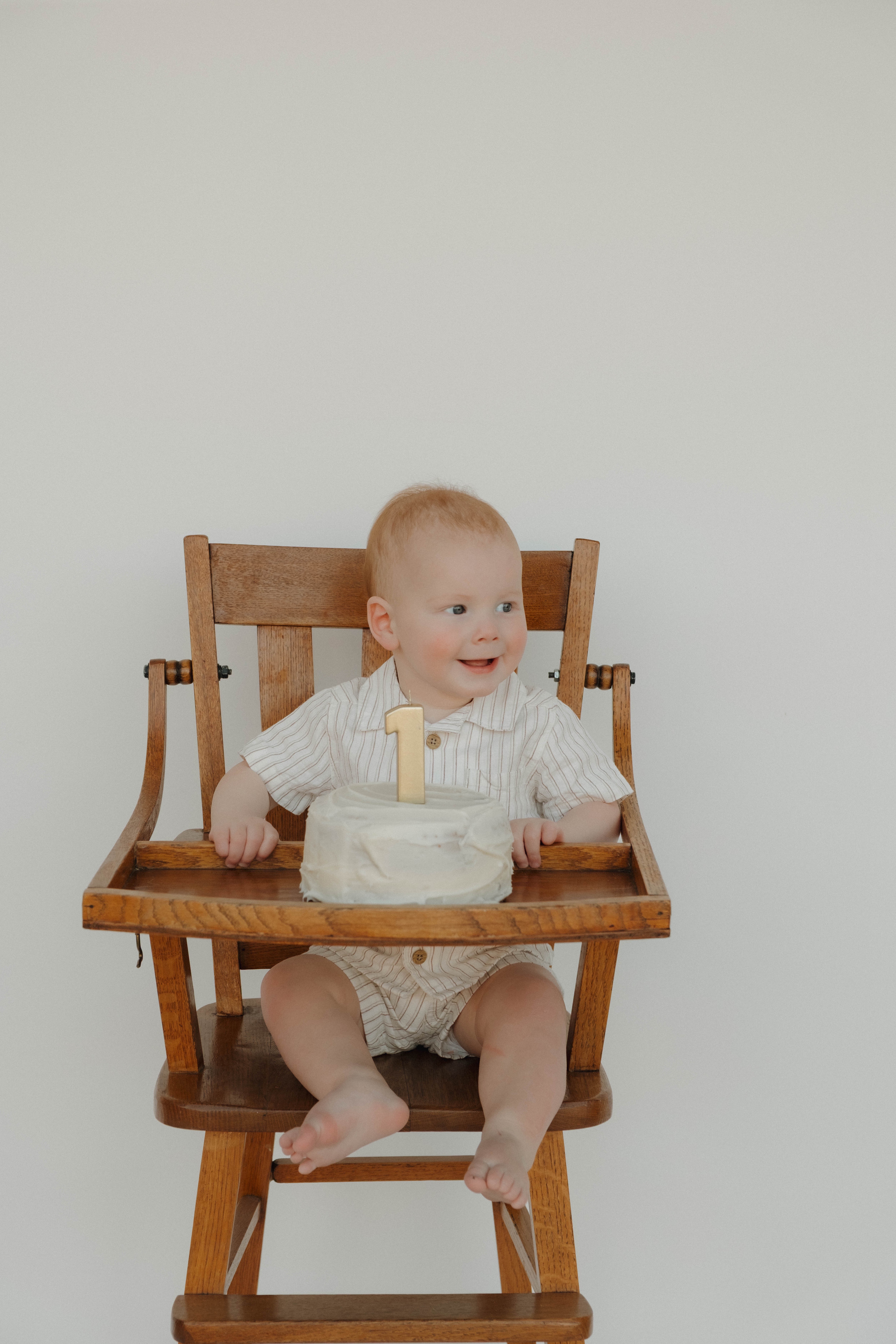 In-home newborn lifestyle photoshoot in Chandler, Arizona, featuring parents with their newborn baby and family dog on a bed.