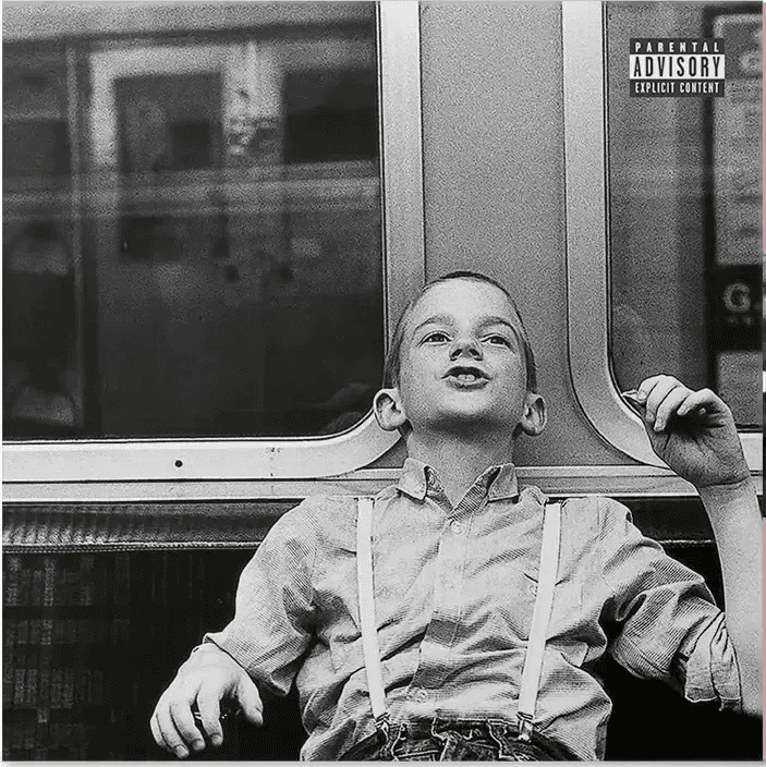 A modern brick house with a two-car garage, well-manicured lawn, and clear blue sky in the background.